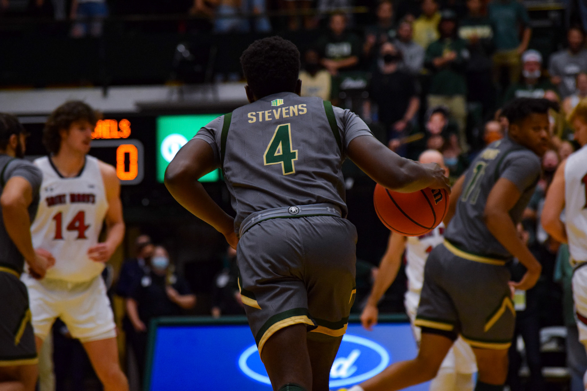 Isaiah Stevens dribbling the ball down the court