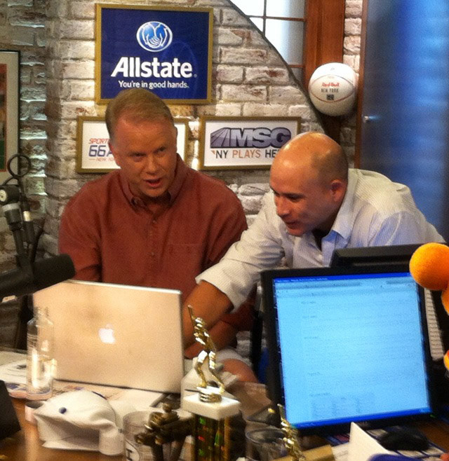 Darren and Boomer Esiason go over the next Genie story during a break at the Boomer & Carton show on WFAN.