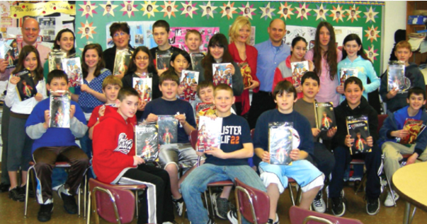 Even the principle (top left) wanted in on this group pic. Free comics for everyone!