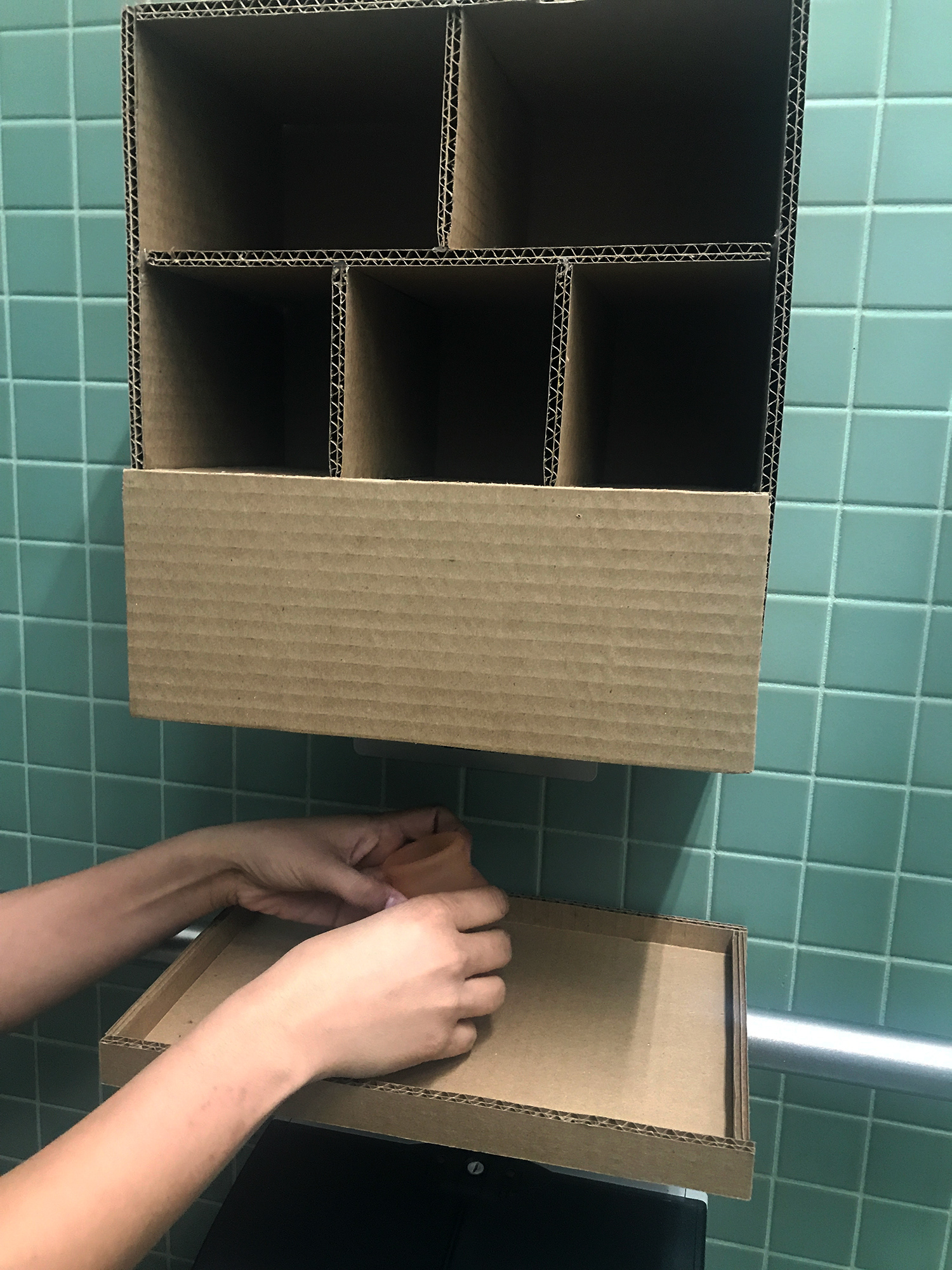 The foot button activates the soap and water at the unit. The user can now wash hands/menstrual cup/soiled garments from inside the cubicle.