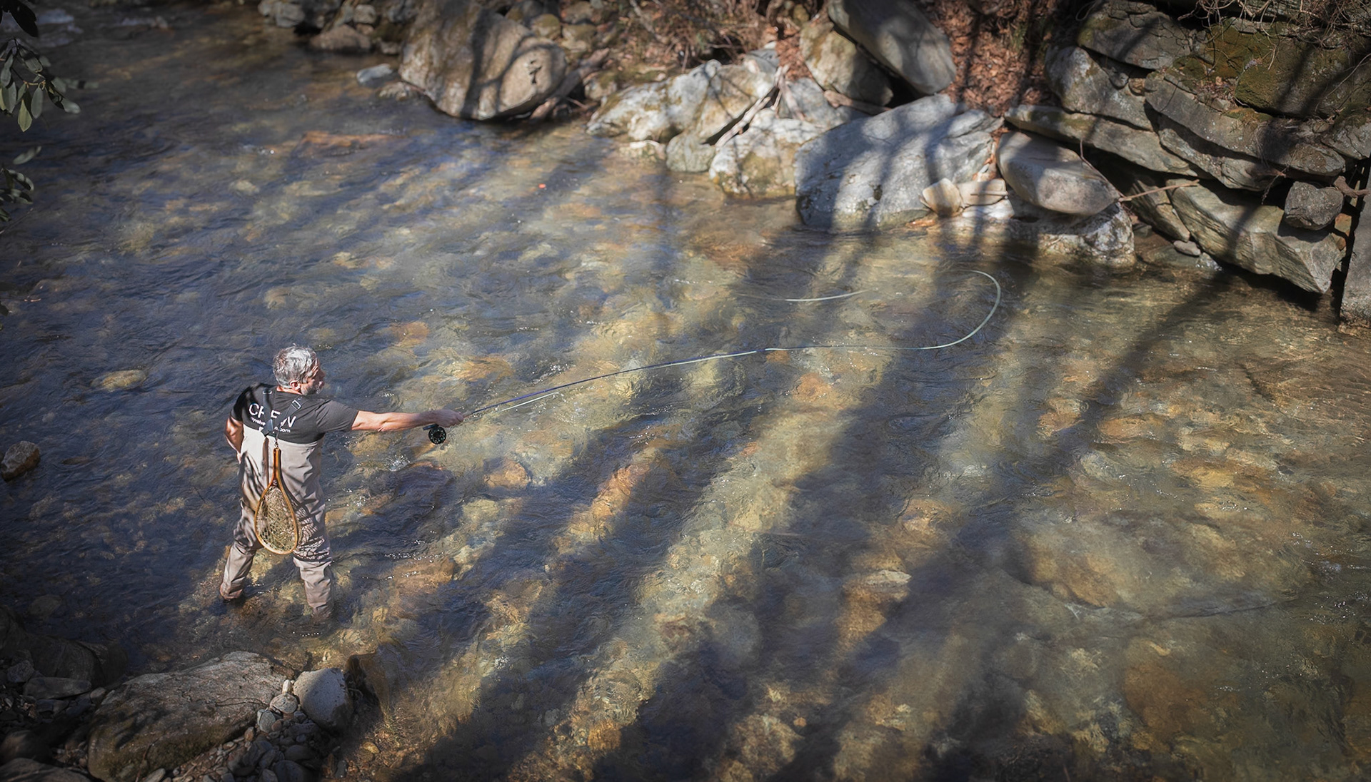 Fly fisherman trying his luck on a pristine mountain stream
