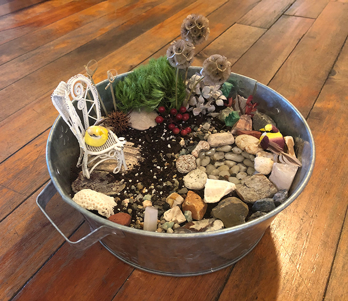 3-D GARDEN LANDSCAPE: stones, soil, wire-wrapped chair, birds, water-filled pool, more