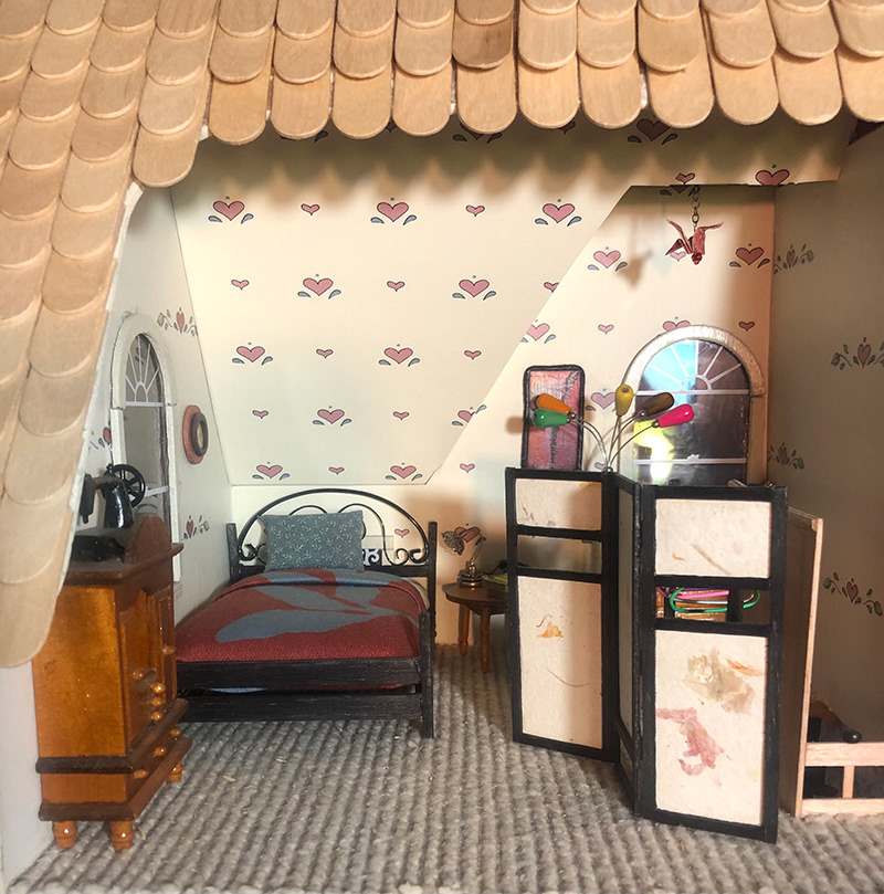 BEDROOM: BED (wood, wire, cloth, stuffing), FOLDING SCREEN (handmade paper, balsa wood), TORCHIERE (wire, wooden beads), BEDSIDE LAMP (beads, wire), ARTWORK, HANGING CRANE (paper)
