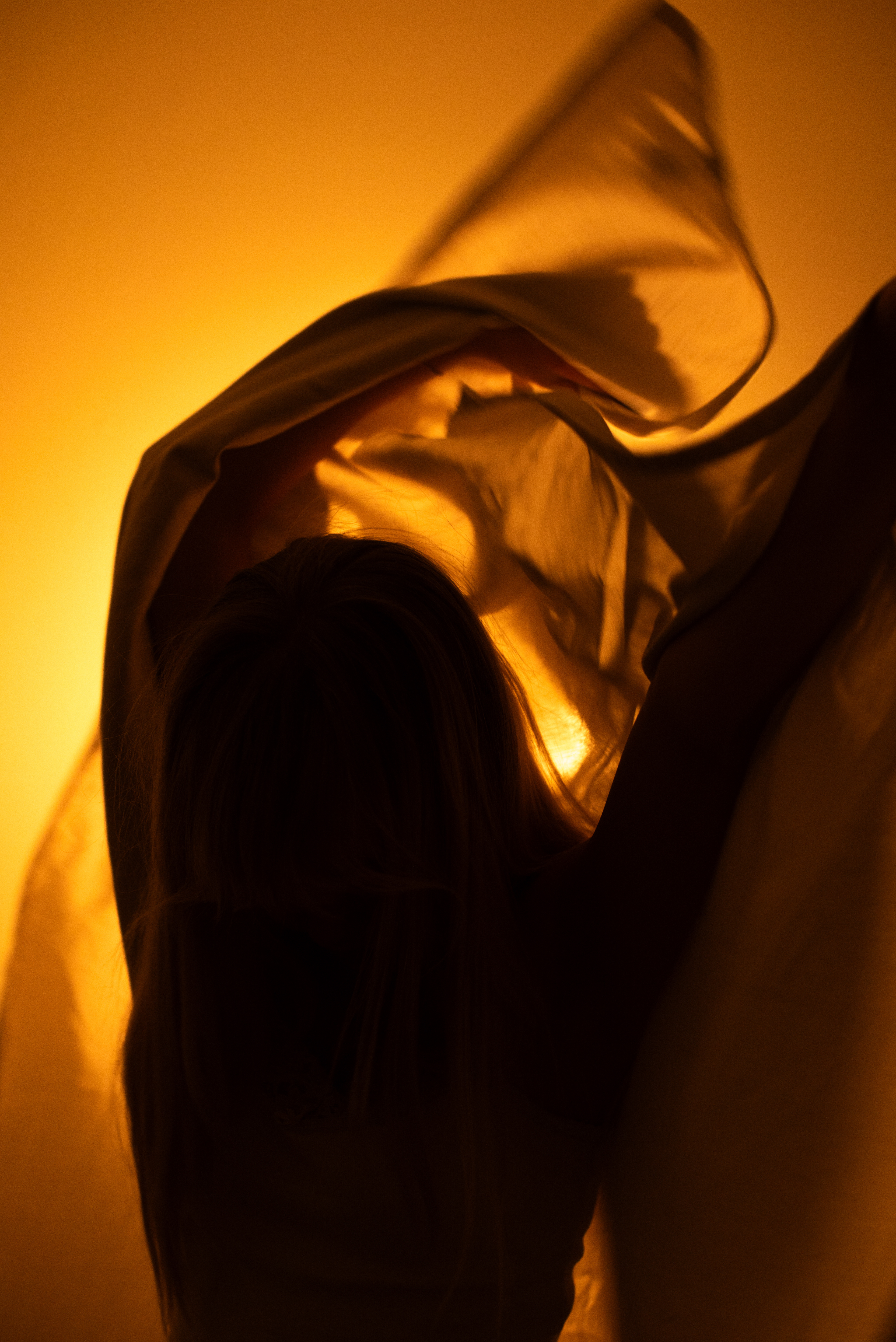 My subject, backlit, created movement with fabric to represent a flickering flame.
