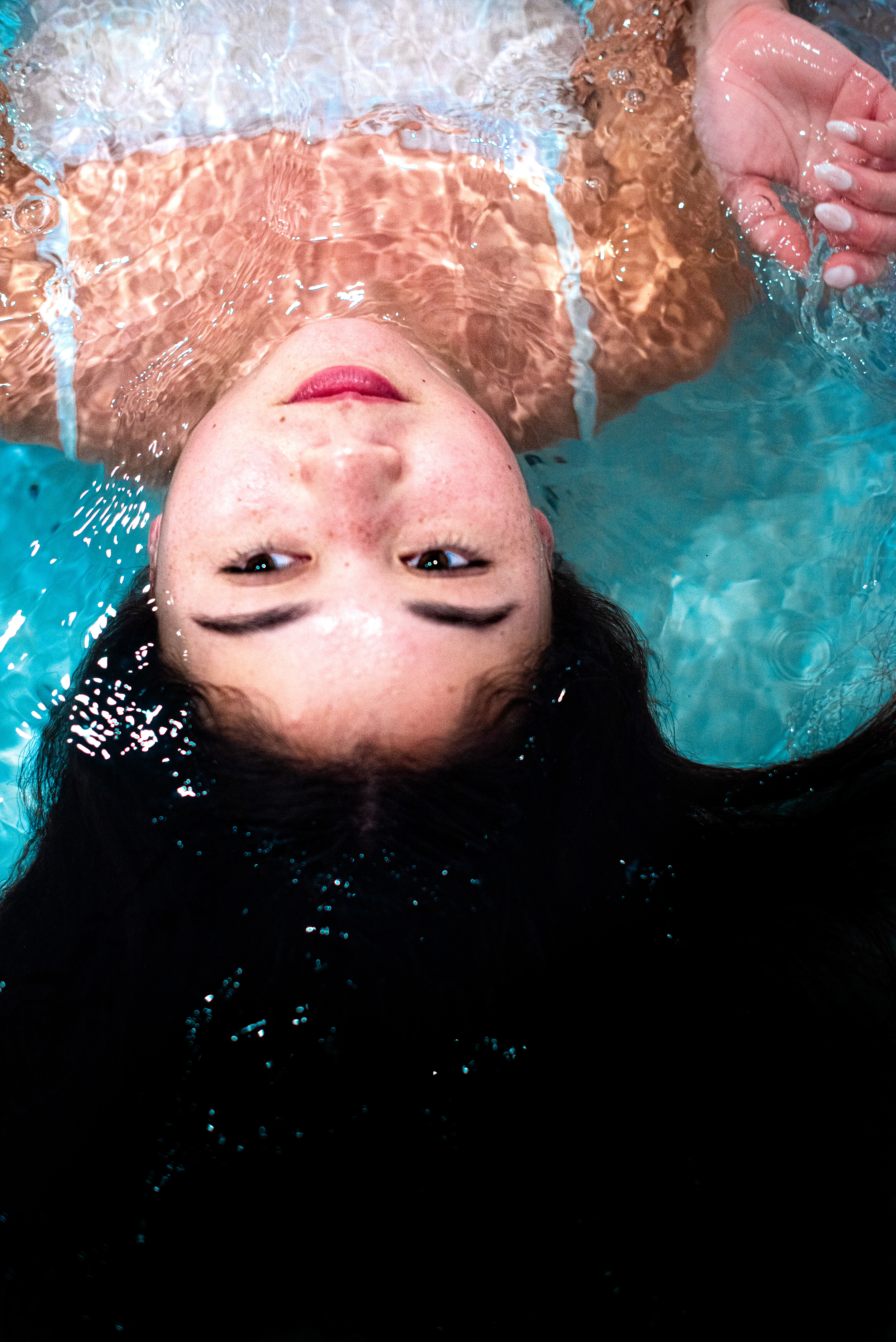 Immersed in water, my subject is serene and unaware of the camera. The ripples blend with her hair and only her face isn't disturb
