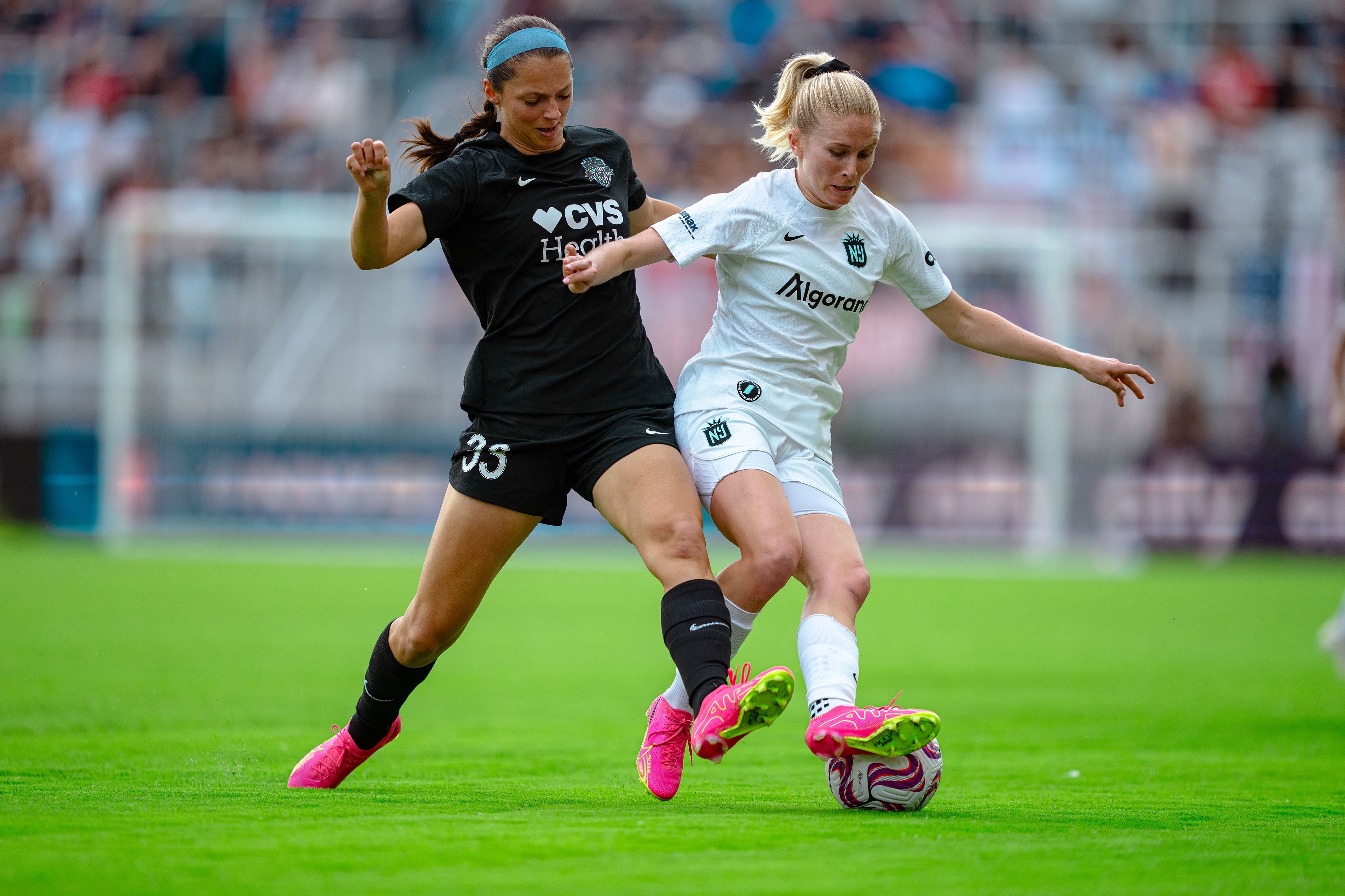 Defender Jenna Nighswonger making a tackle against Ashley Hatch.