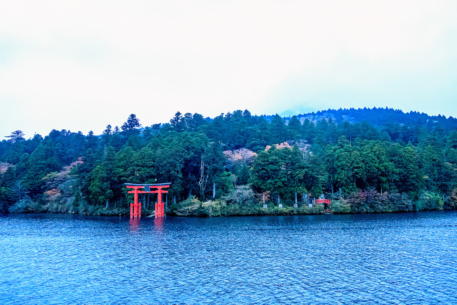 Hakone torii gate viewed from water aboard pirate ship Lake Ashi