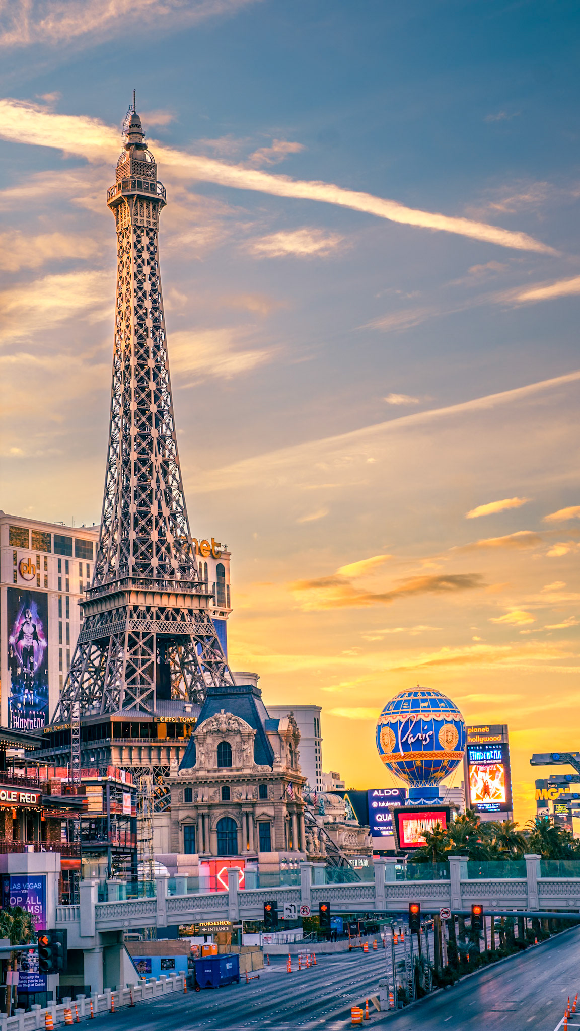 The half‑scale Eiffel Tower at the Paris Las Vegas hotel soars above the Strip, its iron lattice glowing under a desert sunset amid the buzz of Nevada’s entertainment capital.
