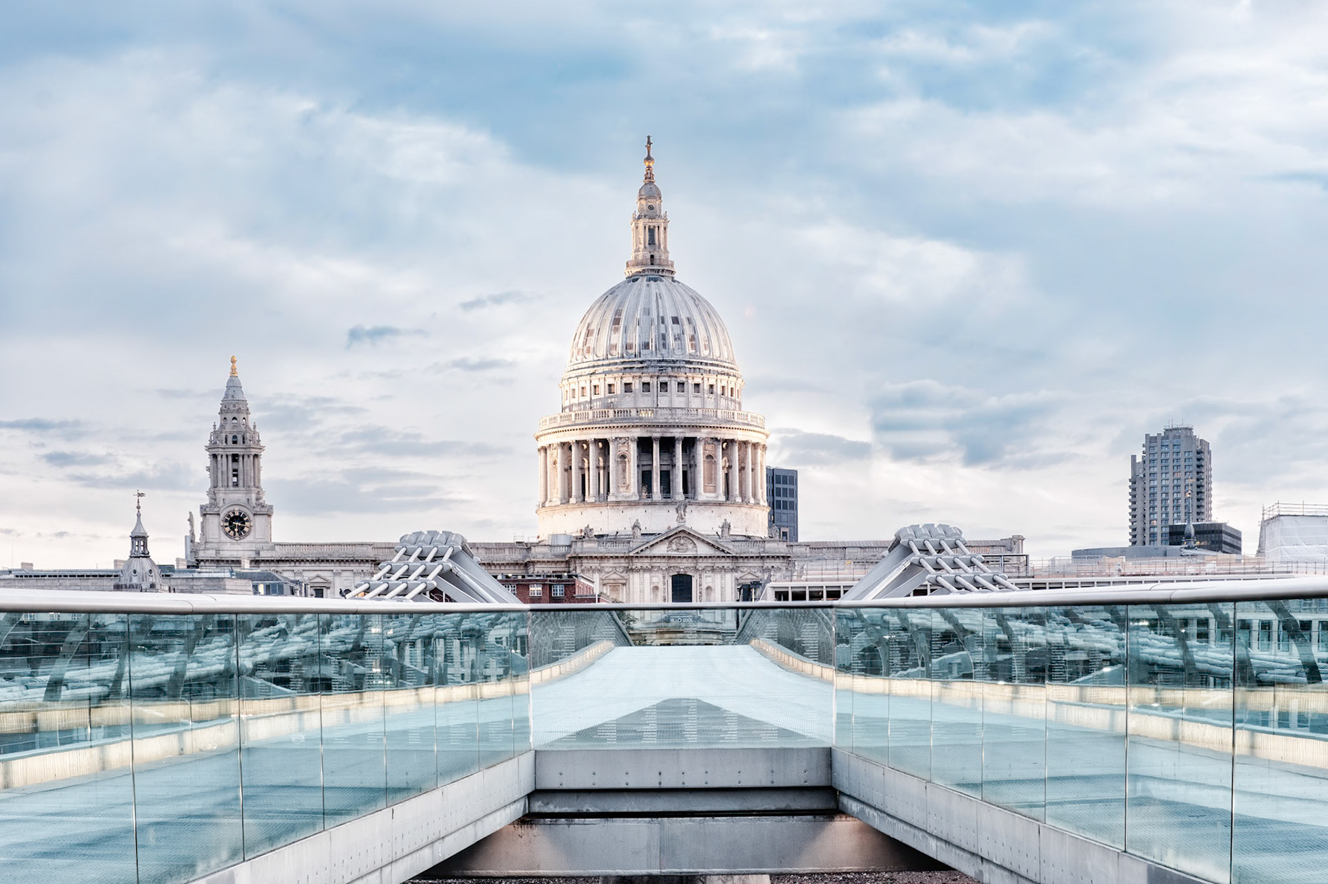 St Paul’s Cathedral stands majestically at the end of the Millennium Bridge, its domed silhouette mirrored in the bridge’s glass balustrades on a crisp London morning.