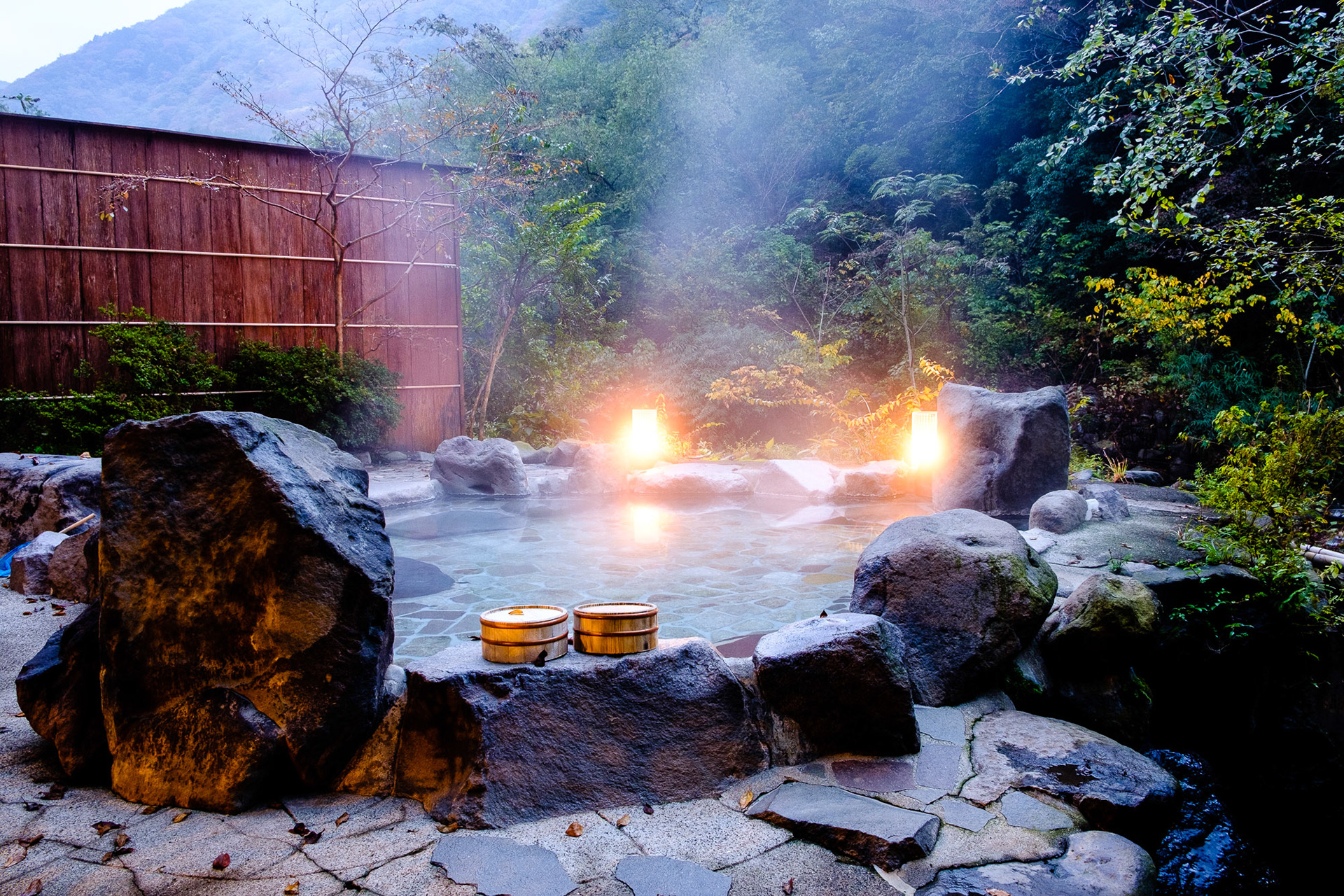 Outdoor onsen hot spring bath at Hakone ryokan with mountain view