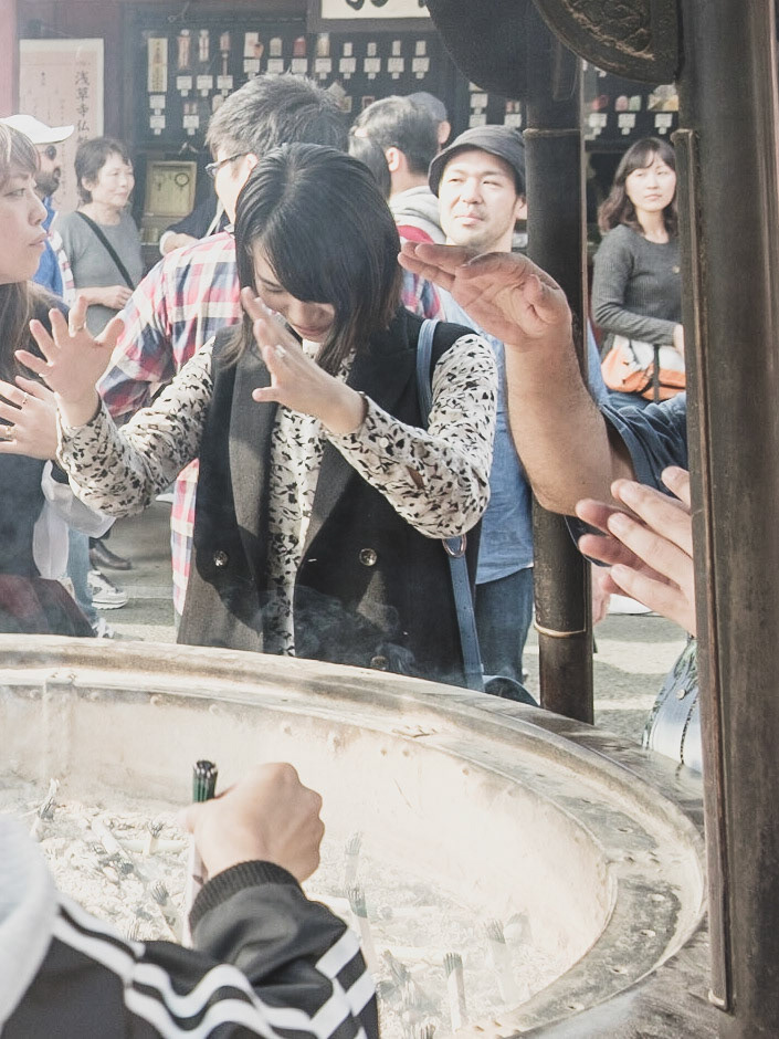 Visitors at Sensō-ji Temple, Asakusa — gathering around the incense burner to draw in good fortune.