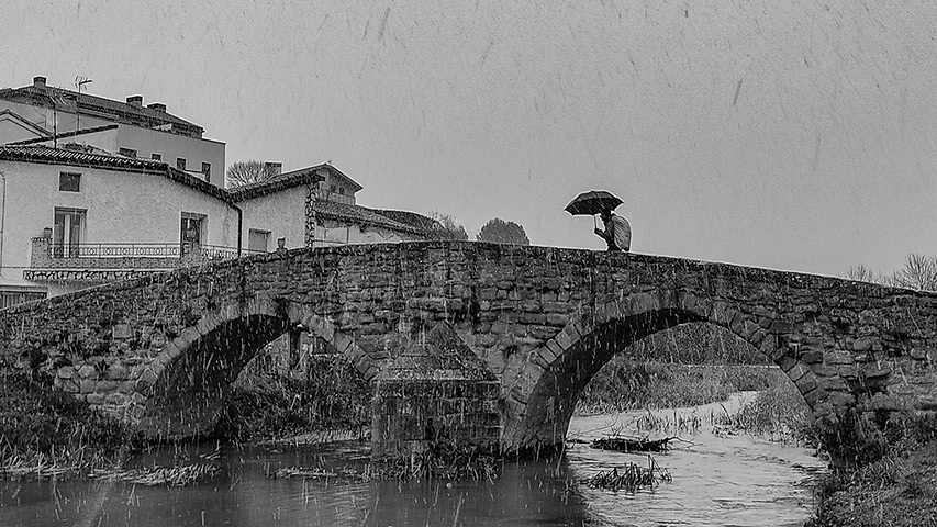Peregrino a su paso por el puente románico, Villatuerta.