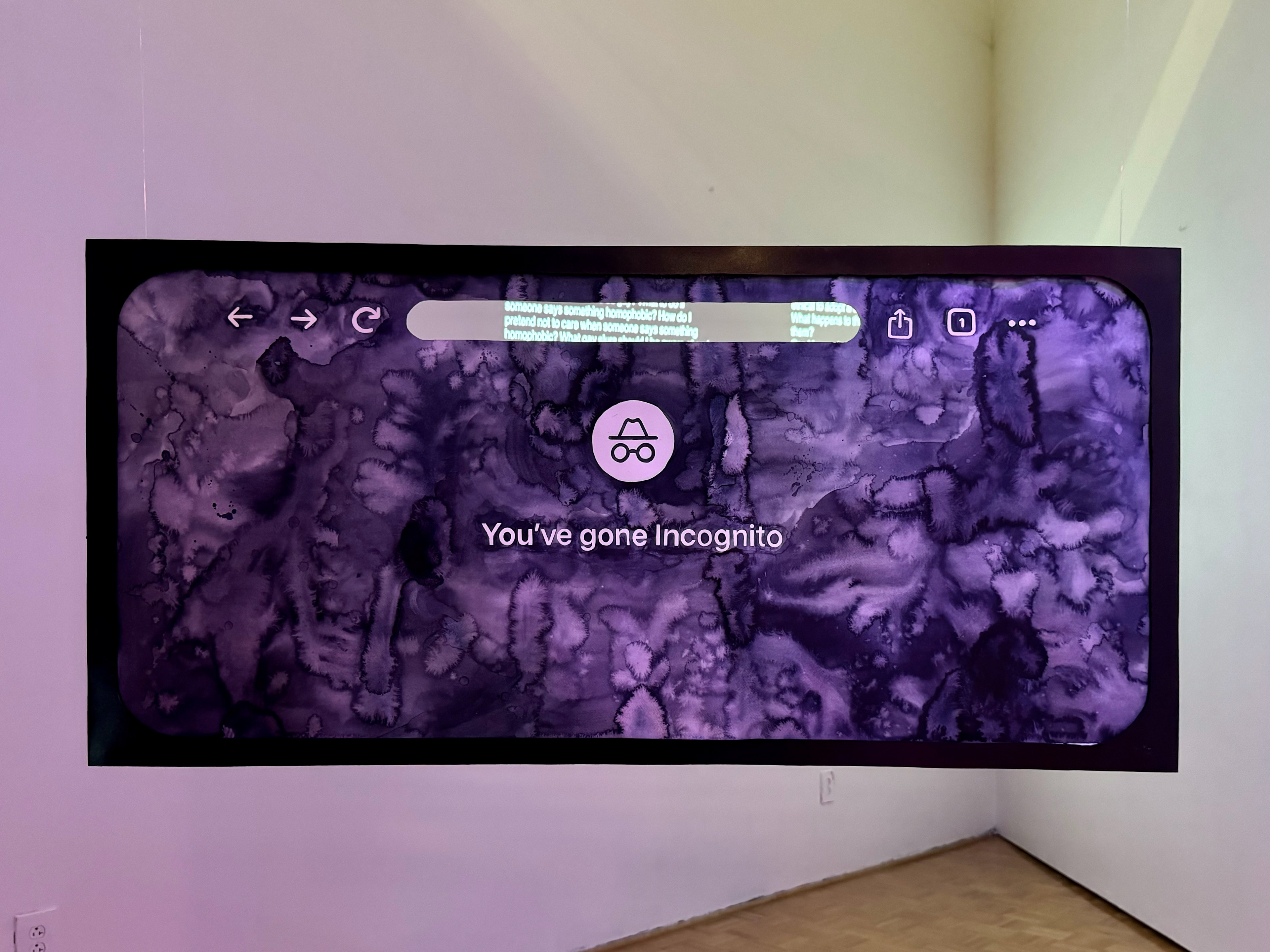 Search installation shot: iPhone private browsing incognito tab in deep purple watercolor, cutout in the search bar reveals text projected on the wall of intimate queer web searches.