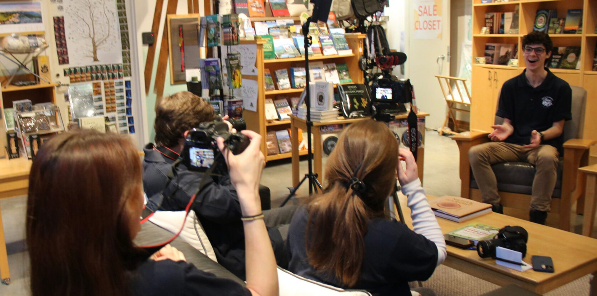 My team with cameras, lighting, and tripods shooting video at The Wild Center