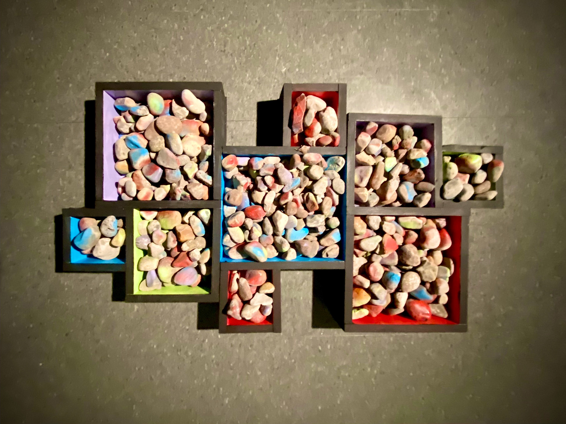 Performance video screenshot: Image of the boxes fully filled with rocks, on the floor at the end of the performance.