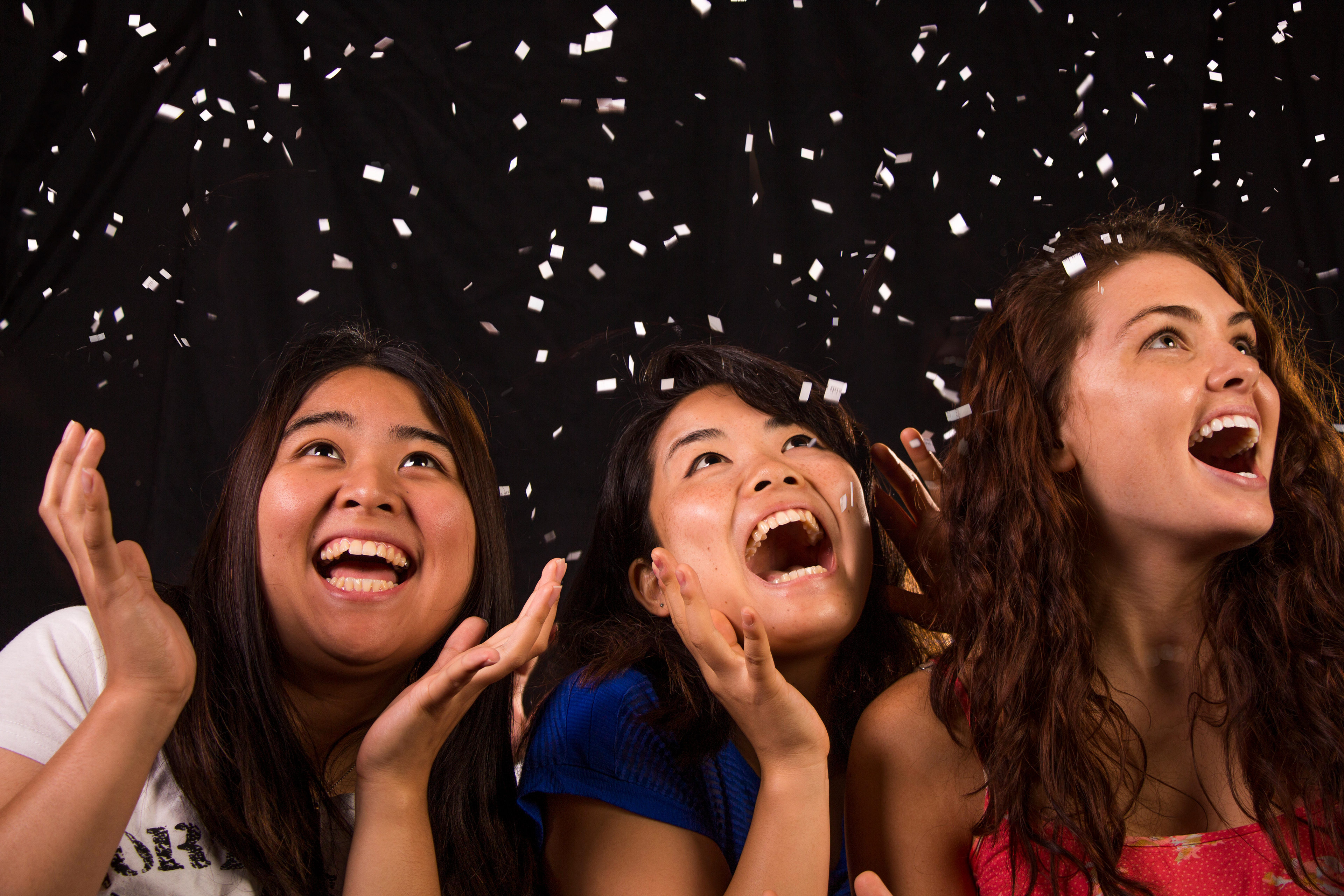 Heightened emotion portrait shot with a studio strobe to freeze the confetti.