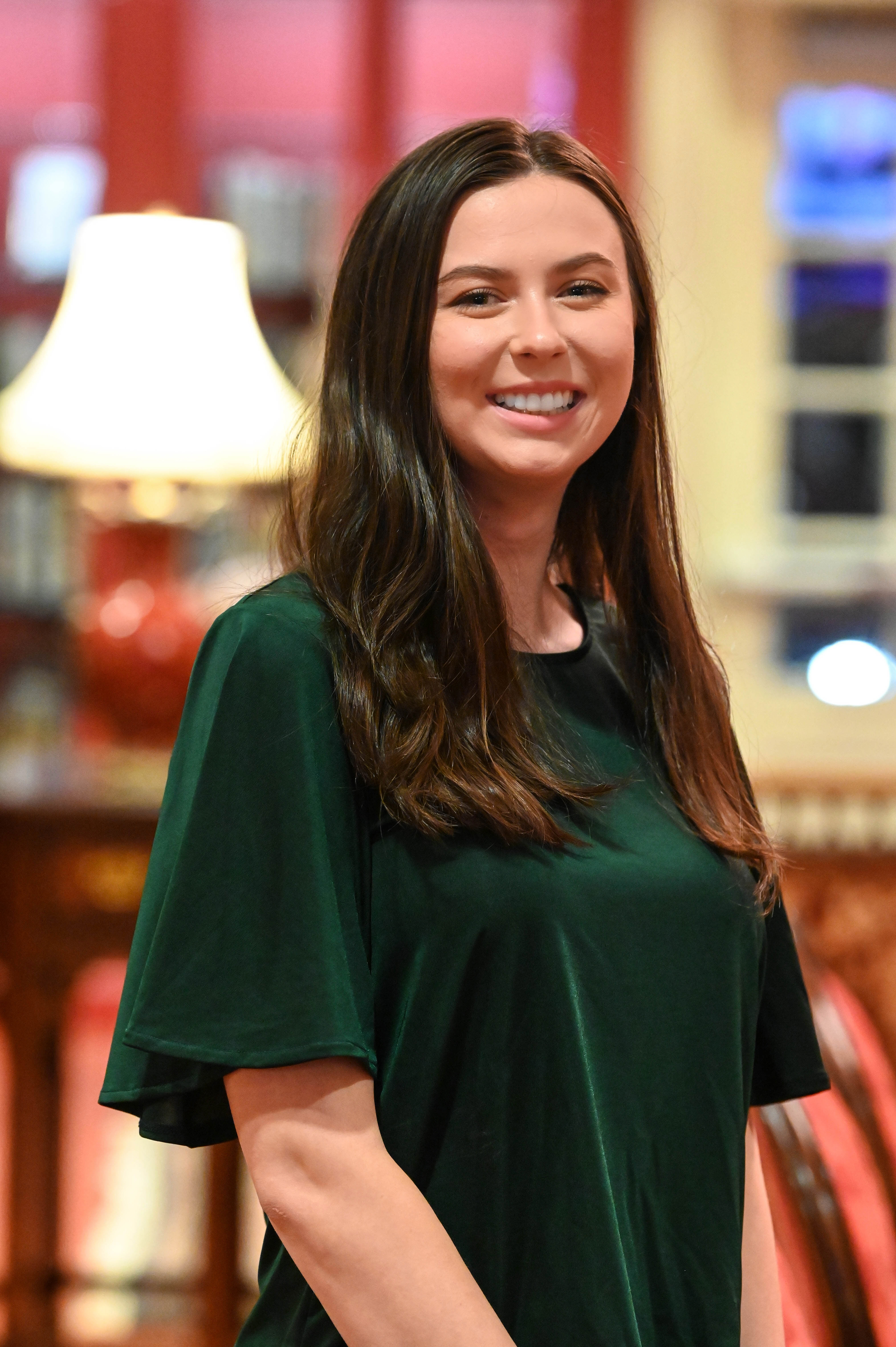 A young business woman standing in an old library