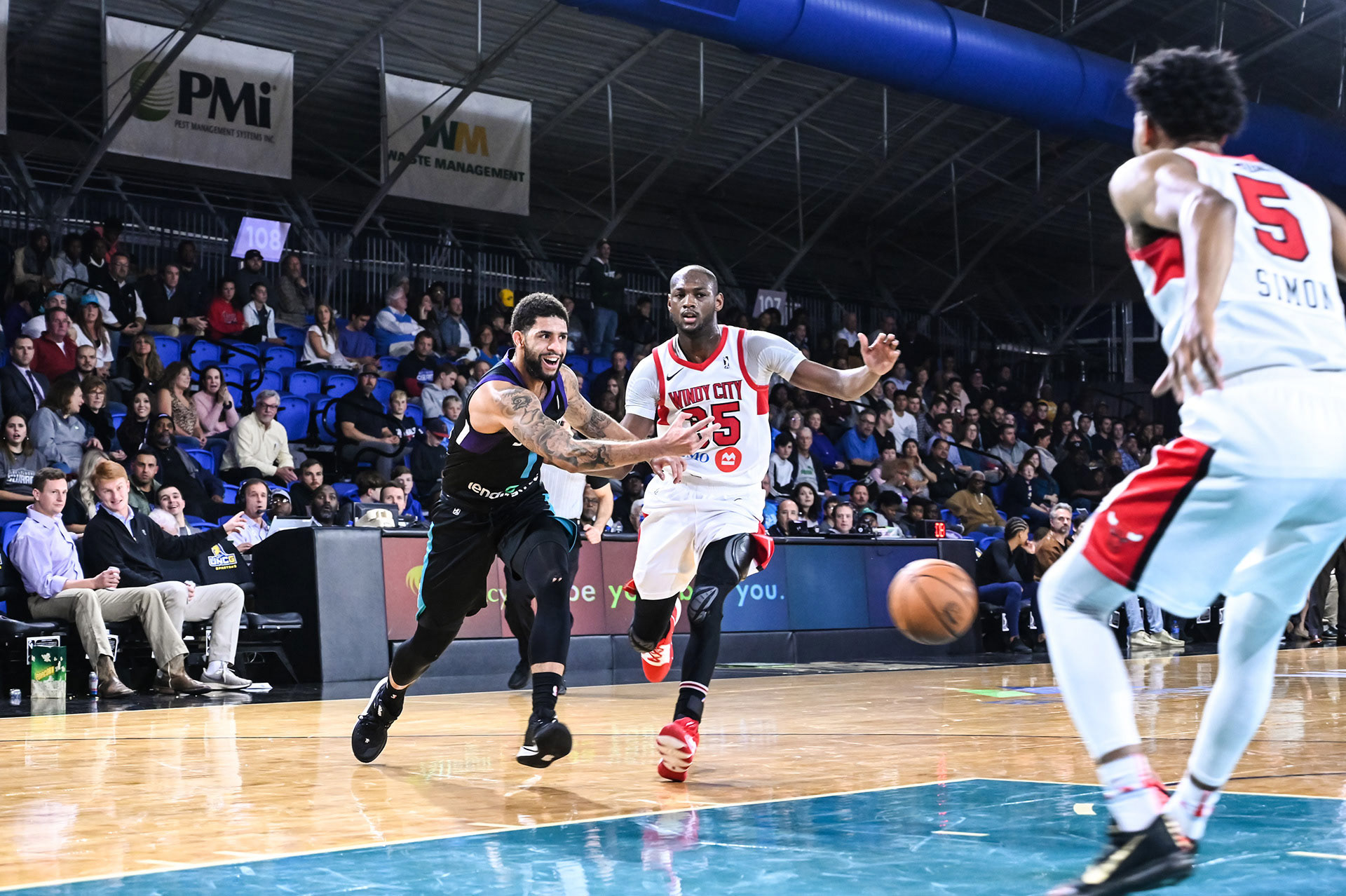 A basketball player doing a bounce pass against the Windy City Bulls