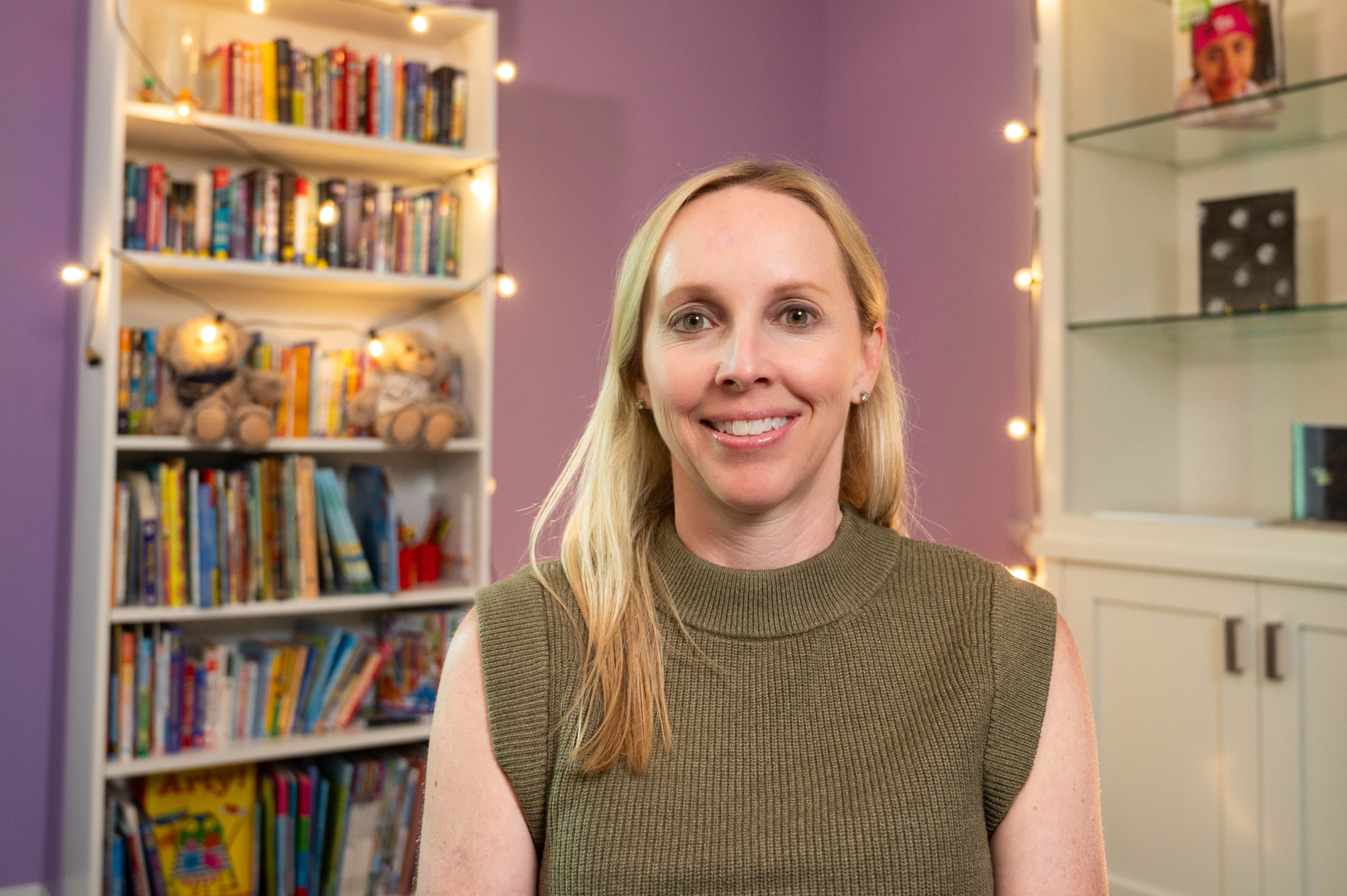 Professional woman sitting in front of children's books and toys