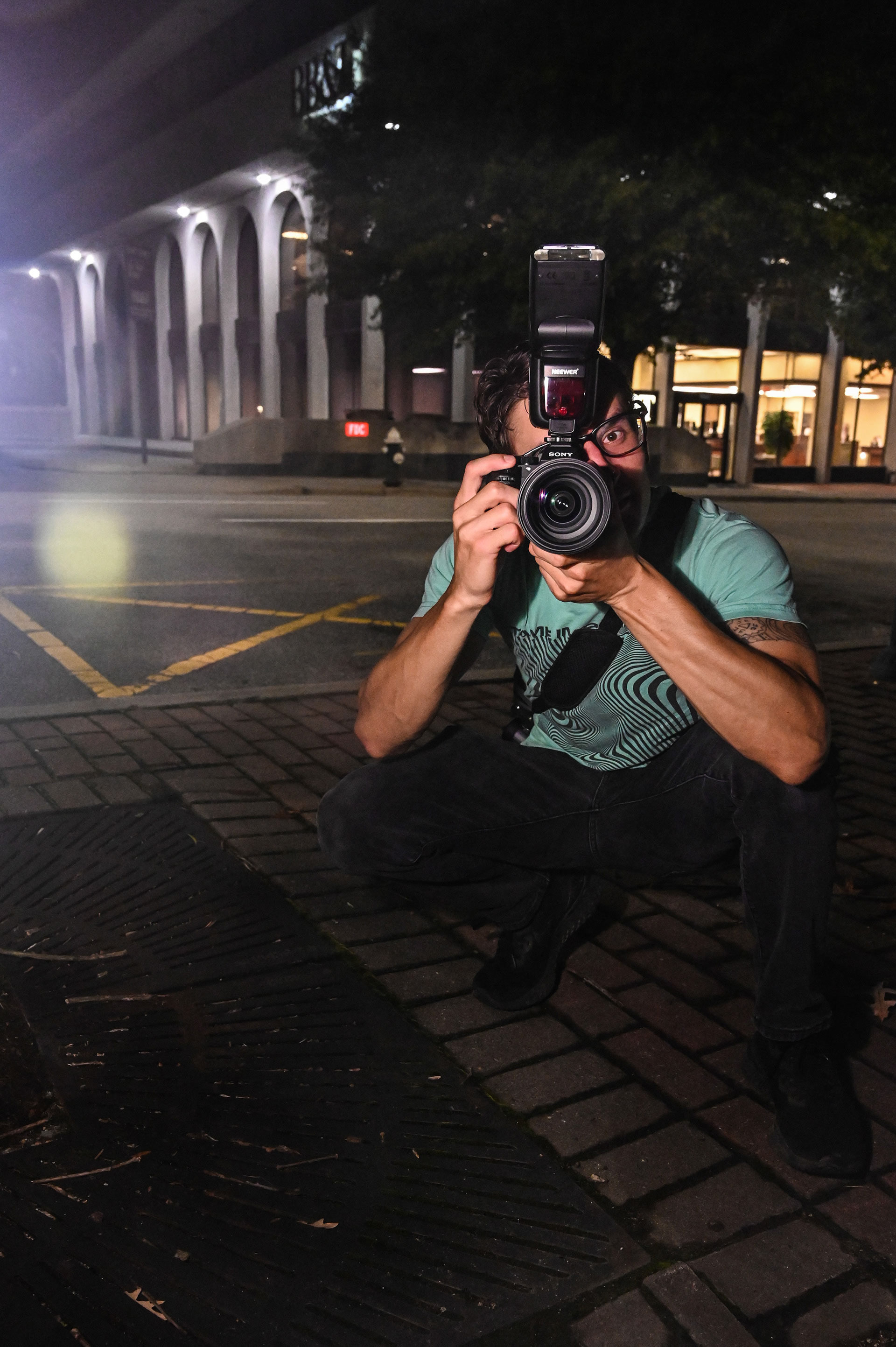 A photographer taking a picture at night