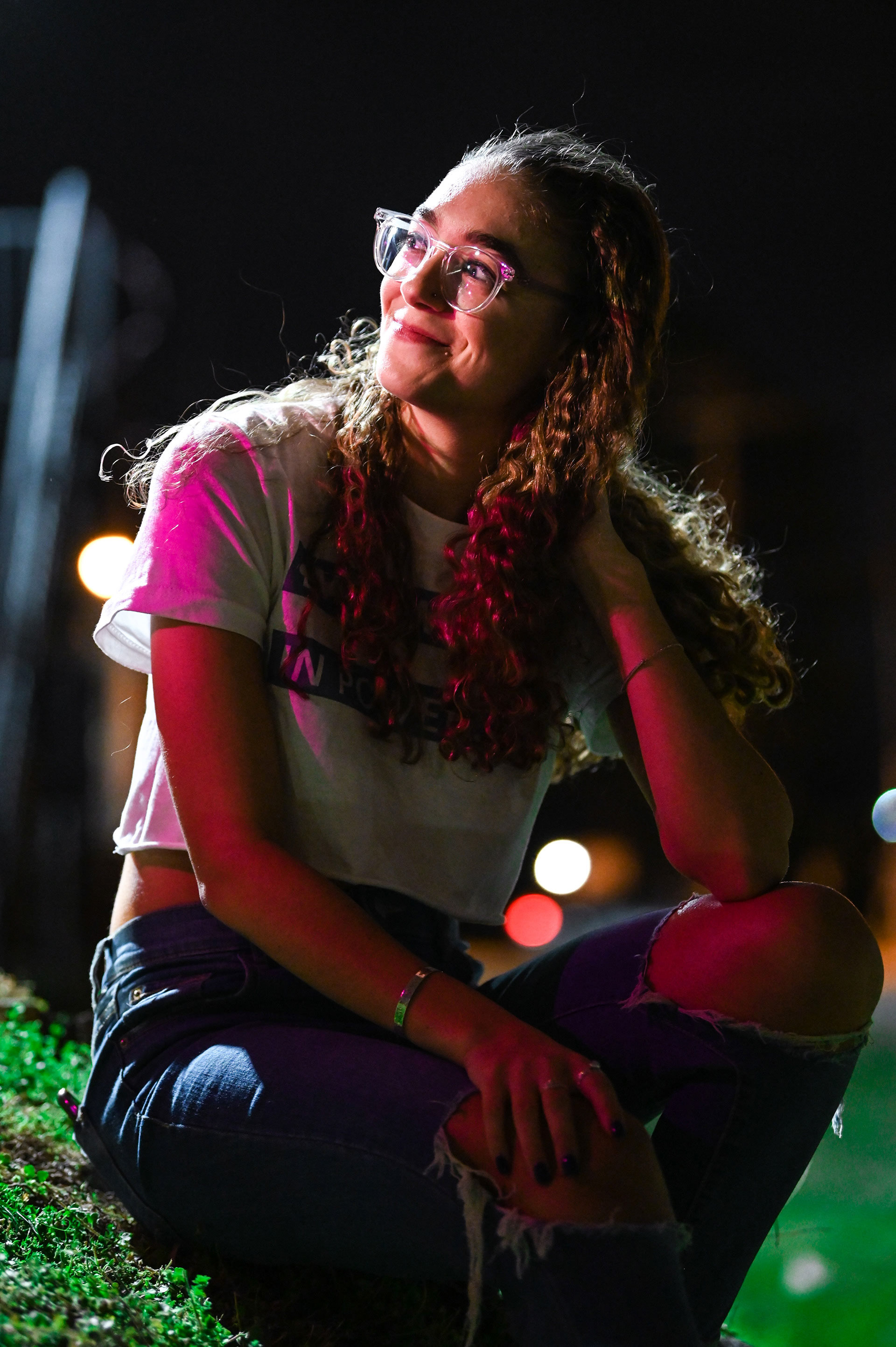 Girl with purple lights on her face and body