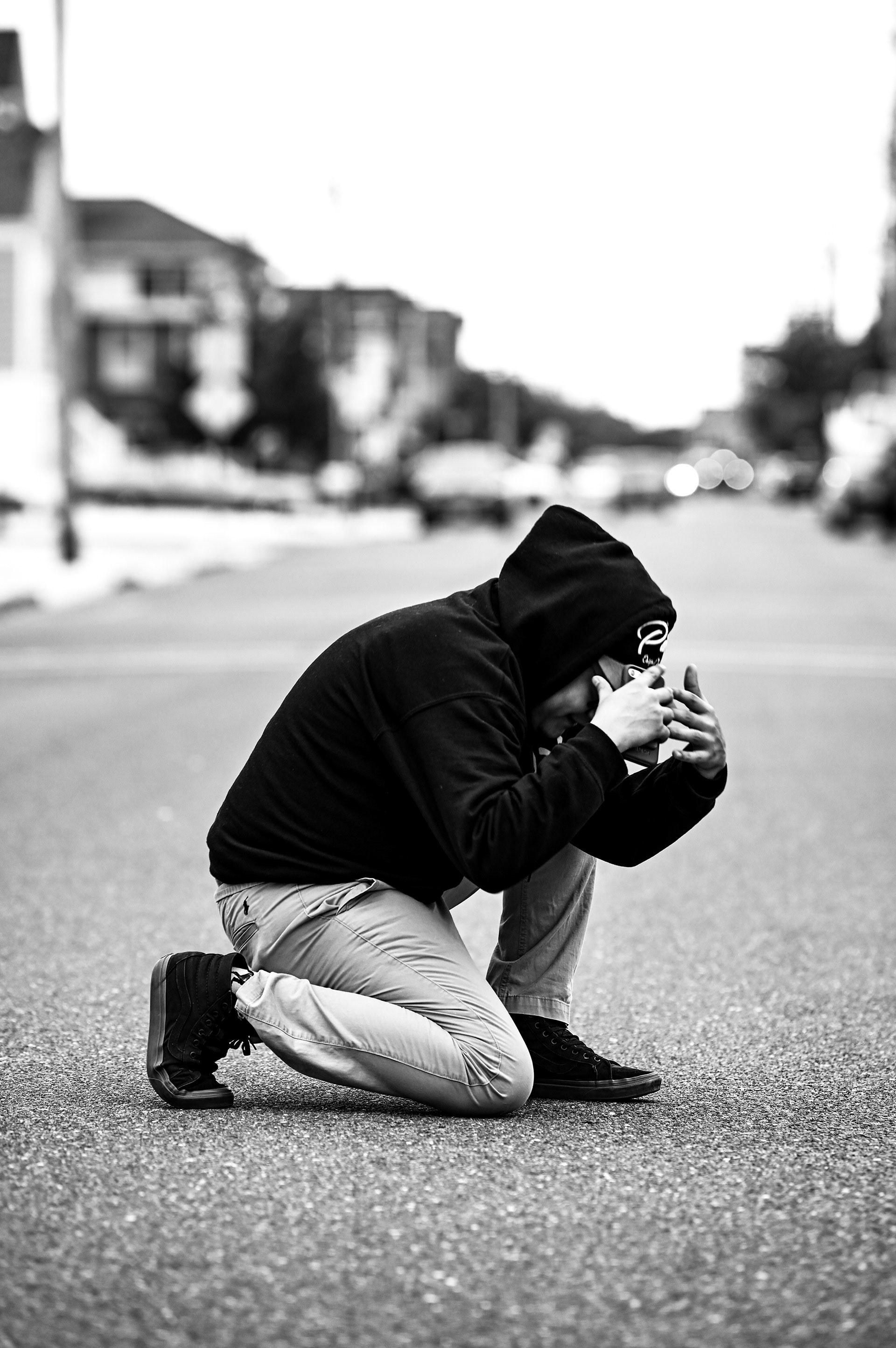 Black and white image of a model standing in the street