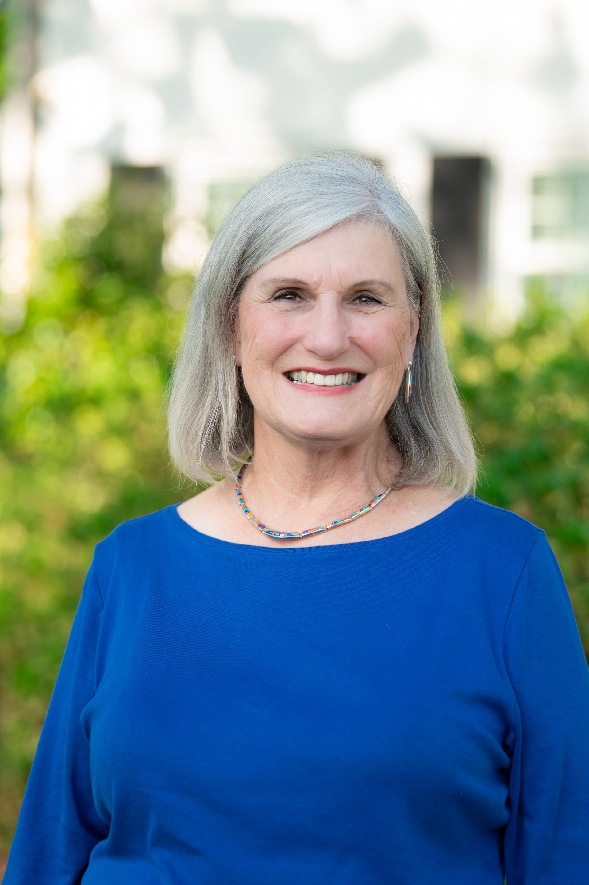 A senior member of the company smiling outside
