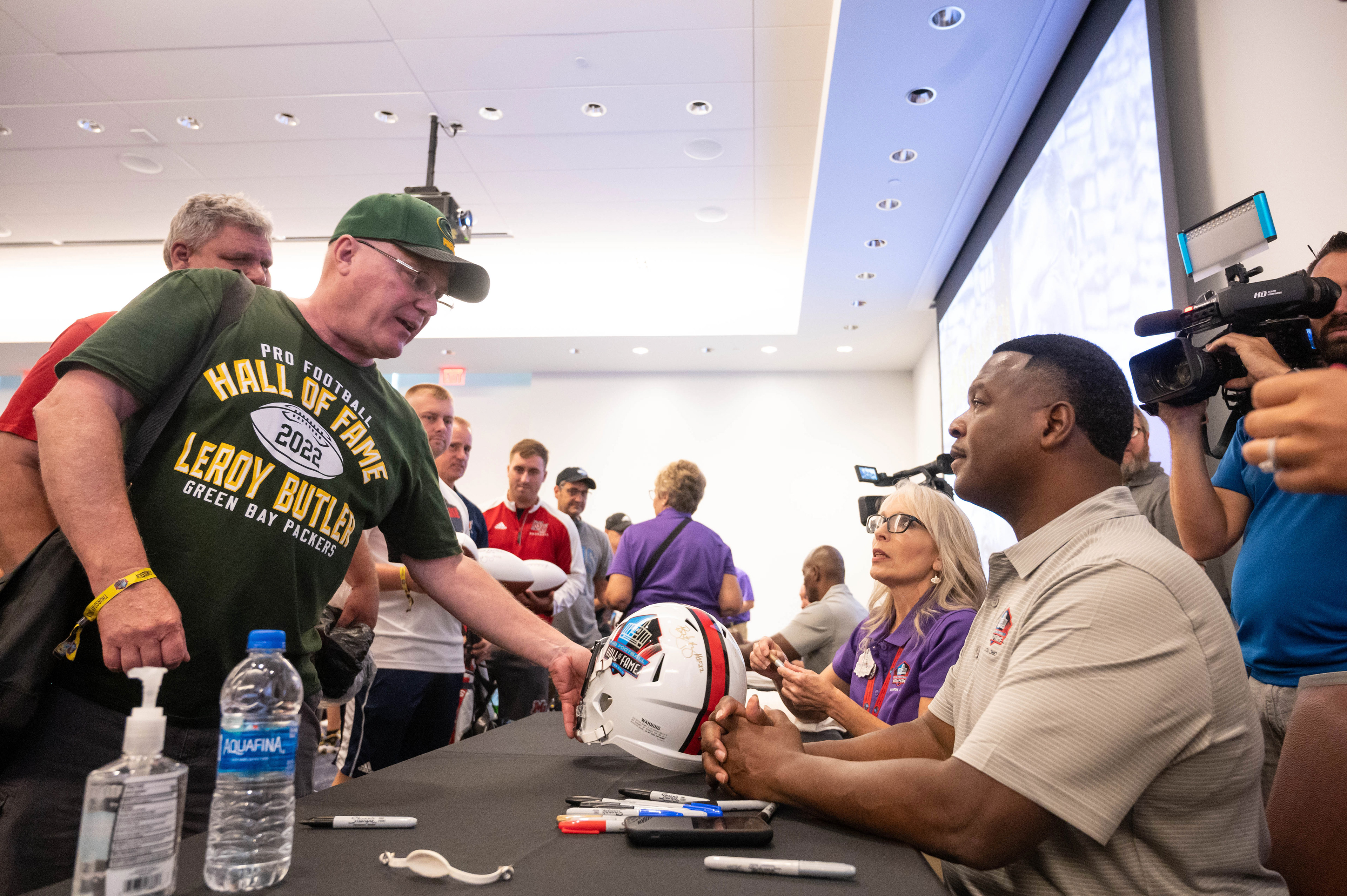 Green bay Packers fan getting an autograph from the founder of the Lambeau Leap