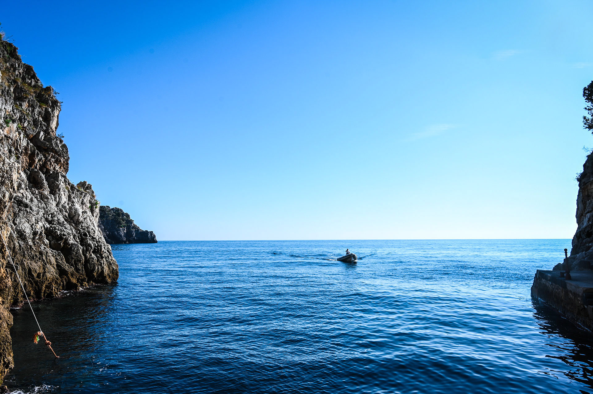 A boat enters the grato in the Amalfi Coast