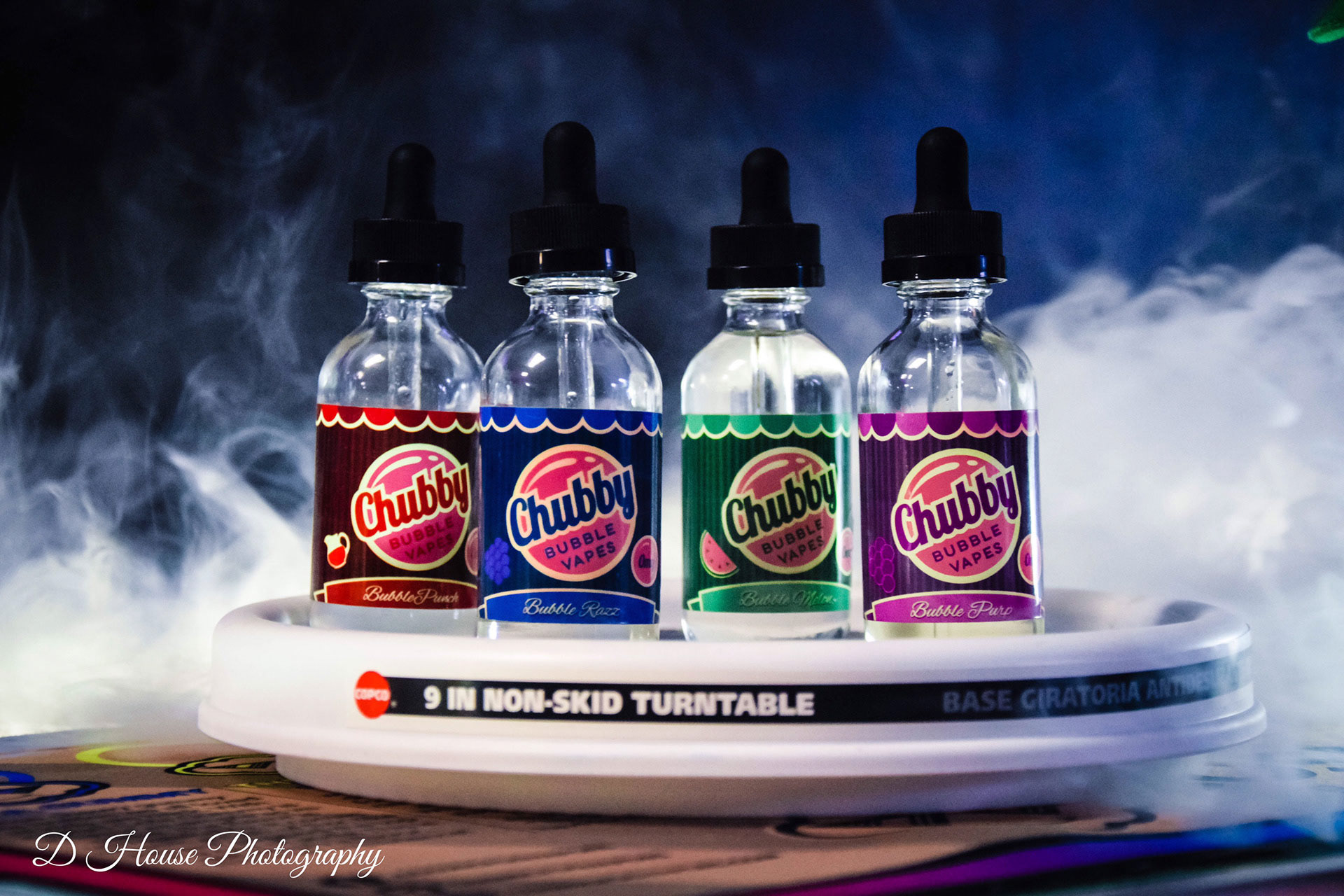 Vape company marketing with smoke behind the bottles