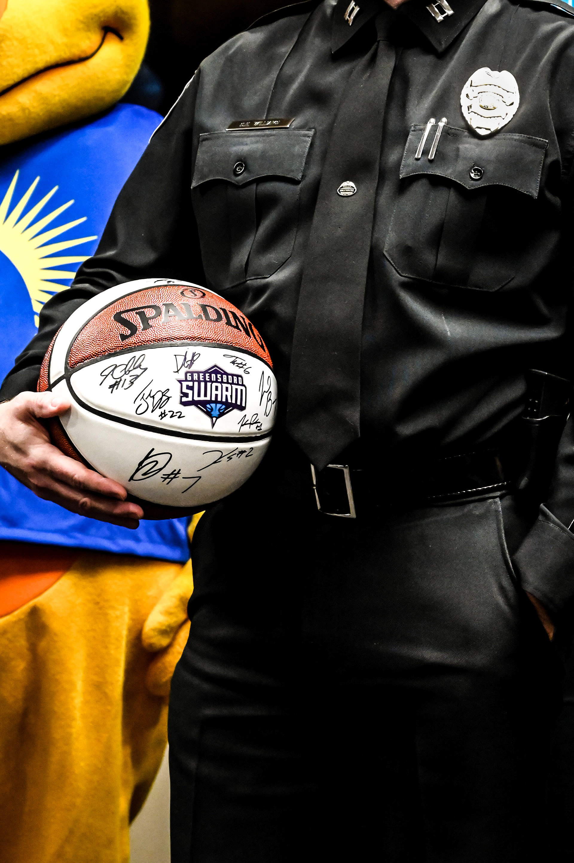 Police officer holding his signed basketball from Charlotte Hornets players