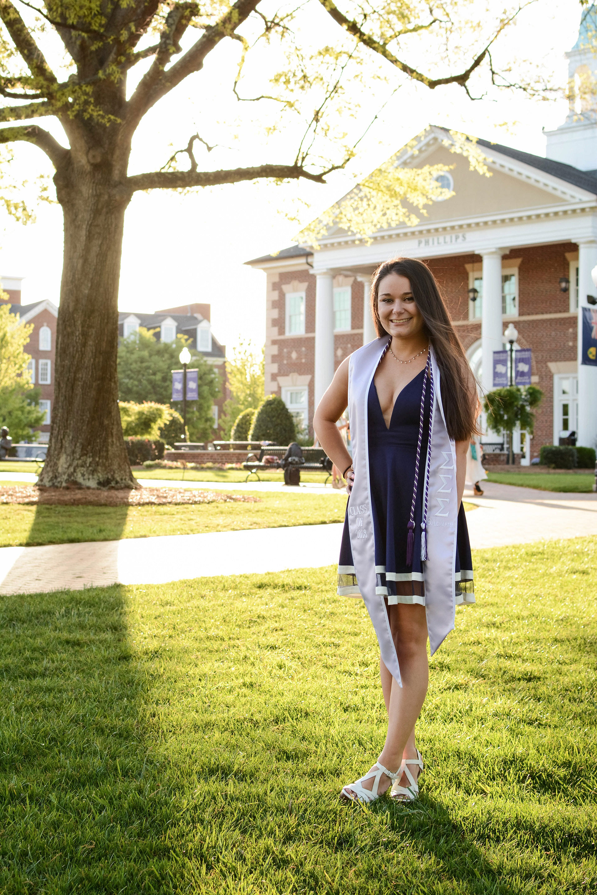 Model posing at sunset for a graduation photoshoot