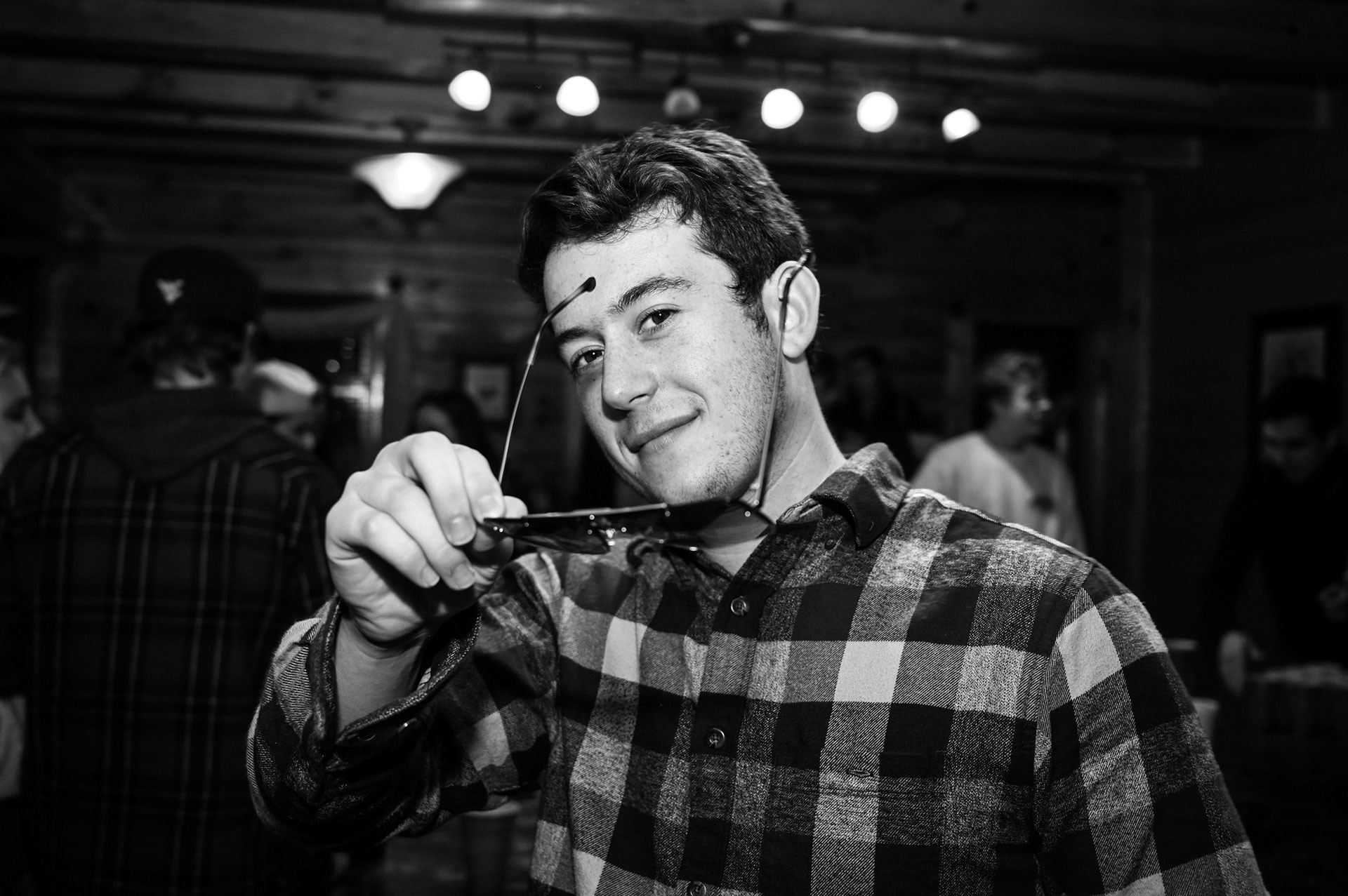 Man holding sunglasses at a party