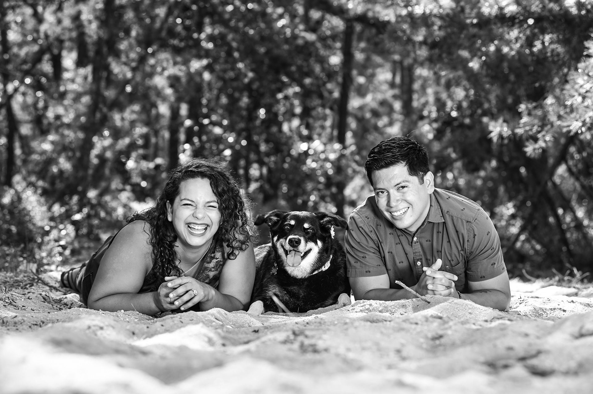 A couple and their dog all smiling together