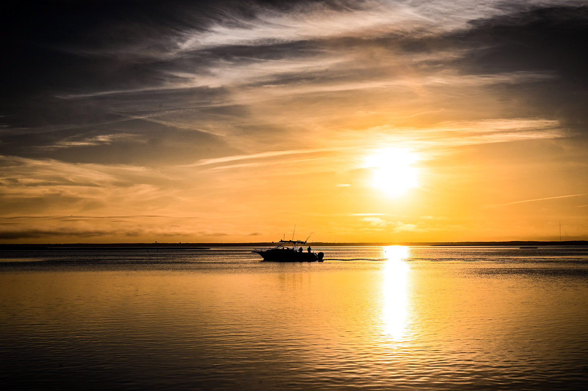 A fishing boat out at sunset