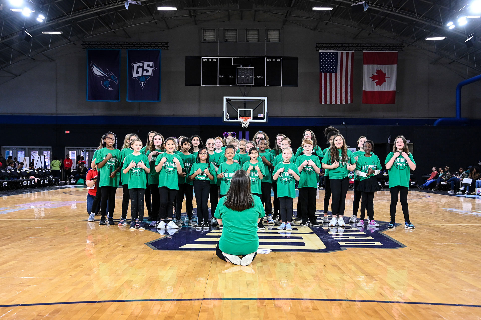 An elementary school chorus singing the National Anthem