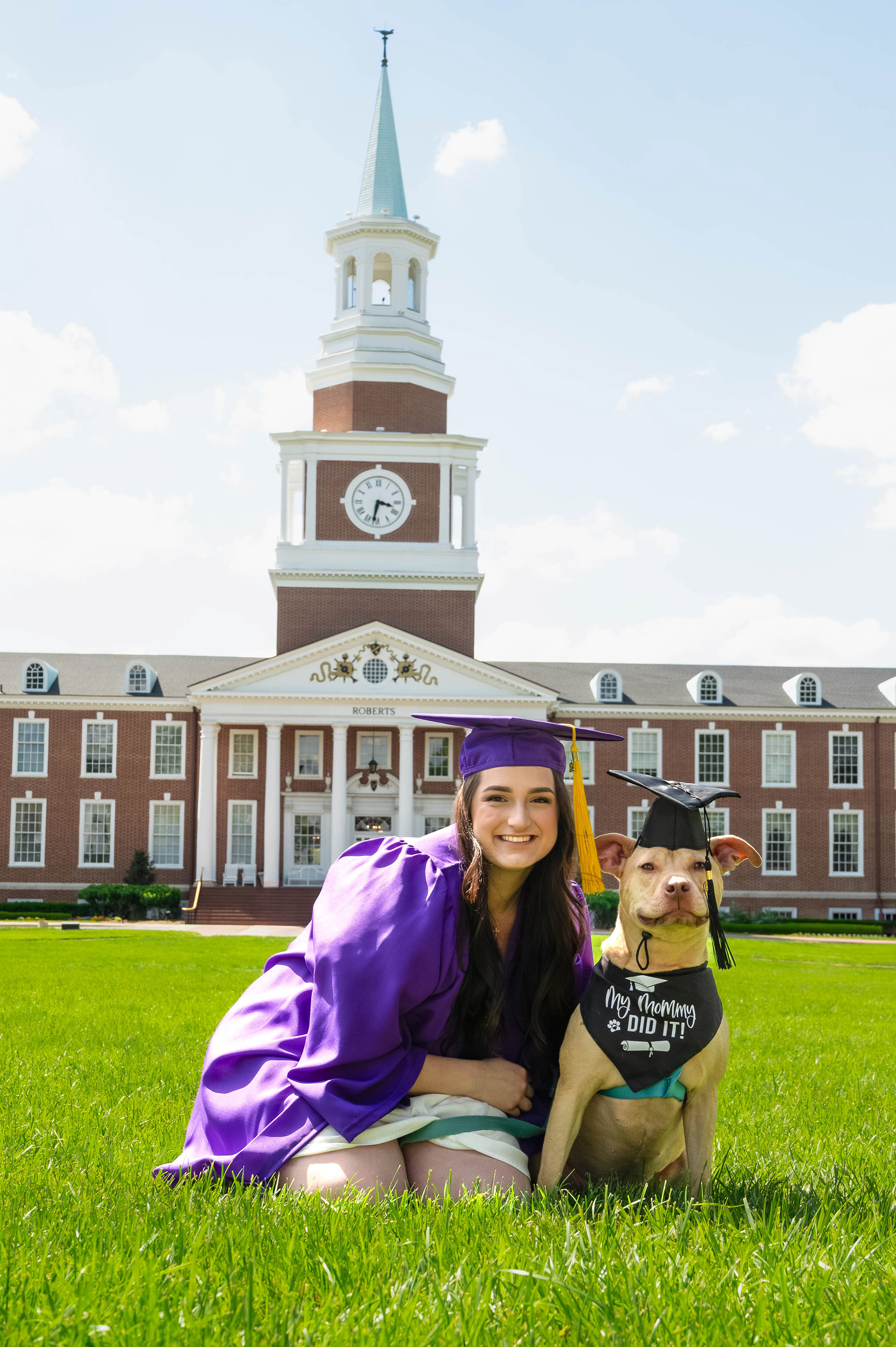 A dog in his cap and gown to match his owner
