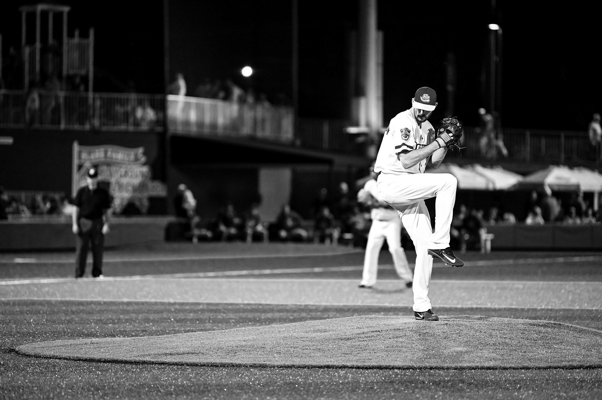 Black and white image of a pitcher preparing his pitch