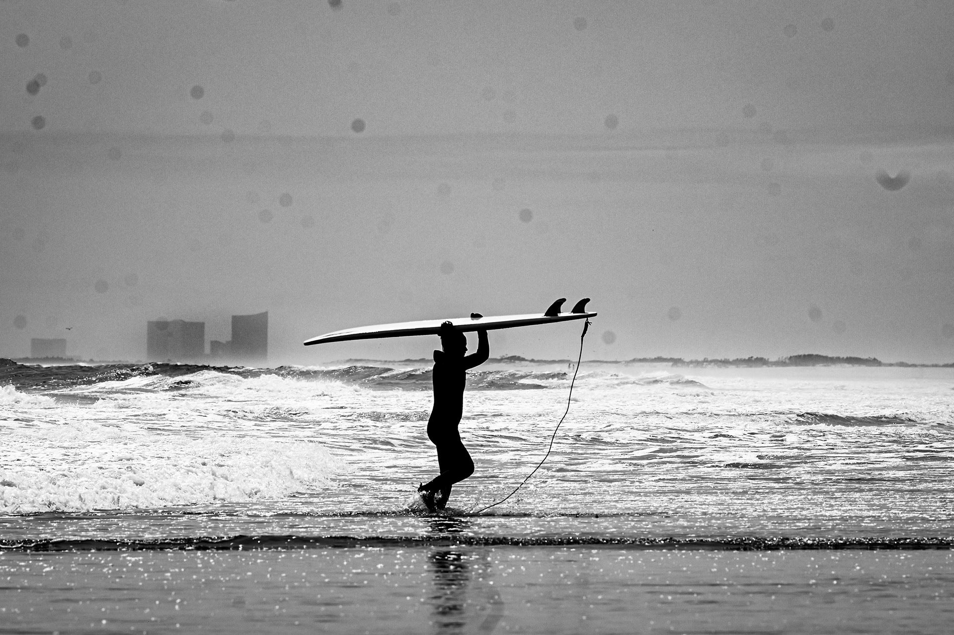 Surfer on a beach during a storm