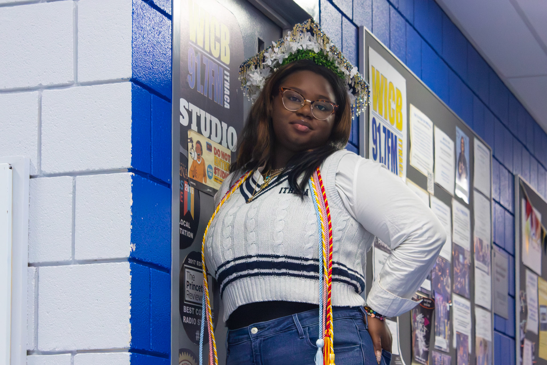 Mureen Doherty '26 proudly posing in front of the WICB Studios