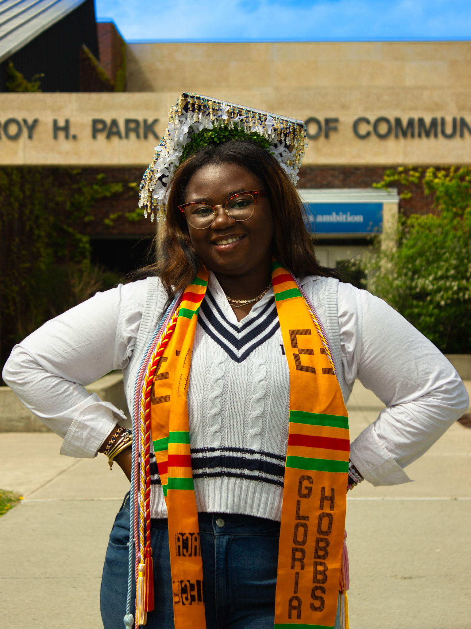 Mureen Doherty '26 proudly posing in front of Roy H. Park School of Communications at Ithaca College