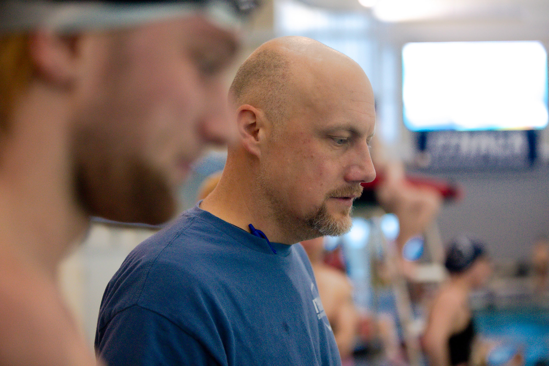 Portrait of Ithaca College Swim and Dive Coach Mike Blakely-Armitage at work during a practice session.
