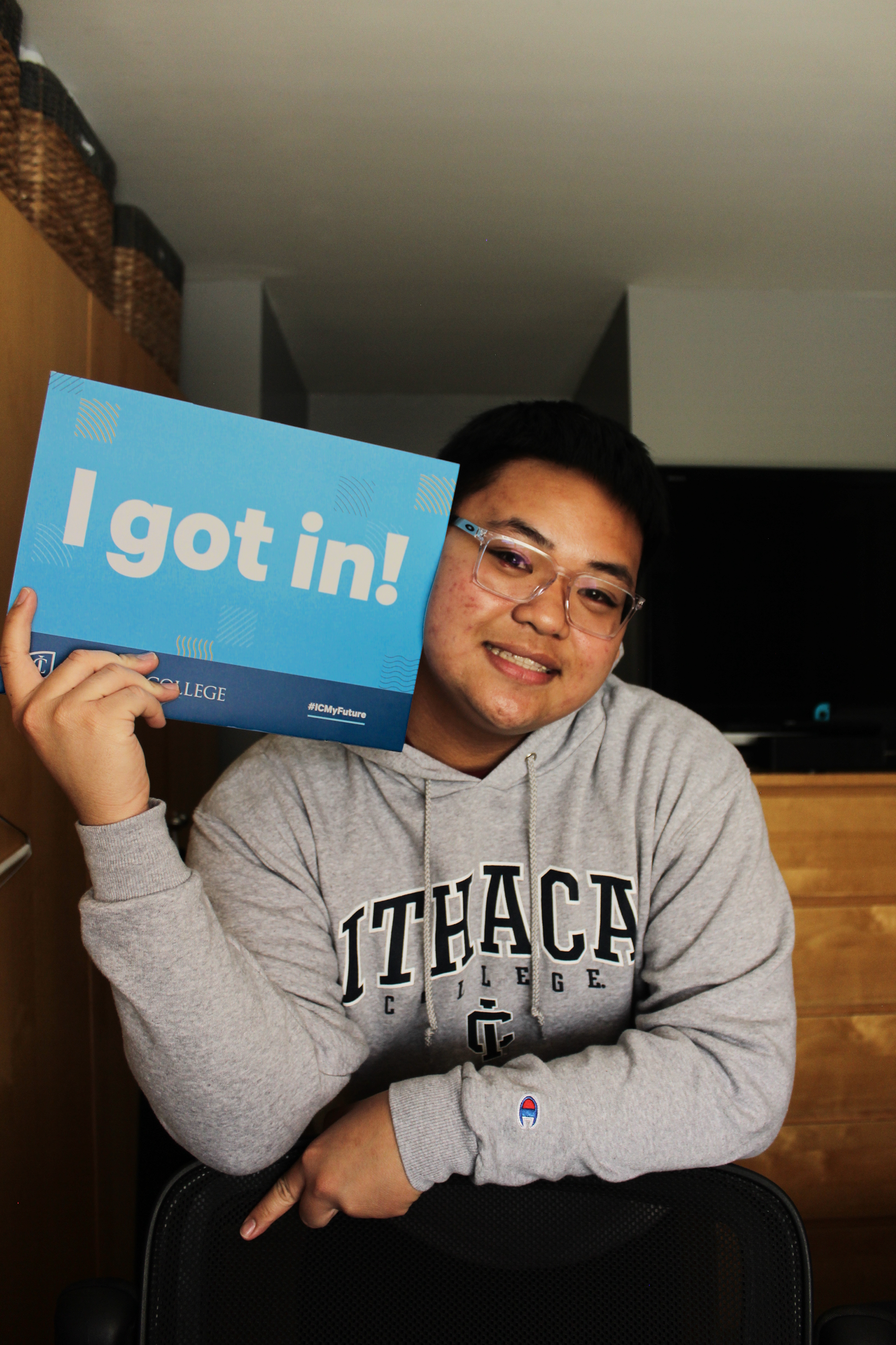 Self-portrait of me with my acceptance package from Ithaca College.