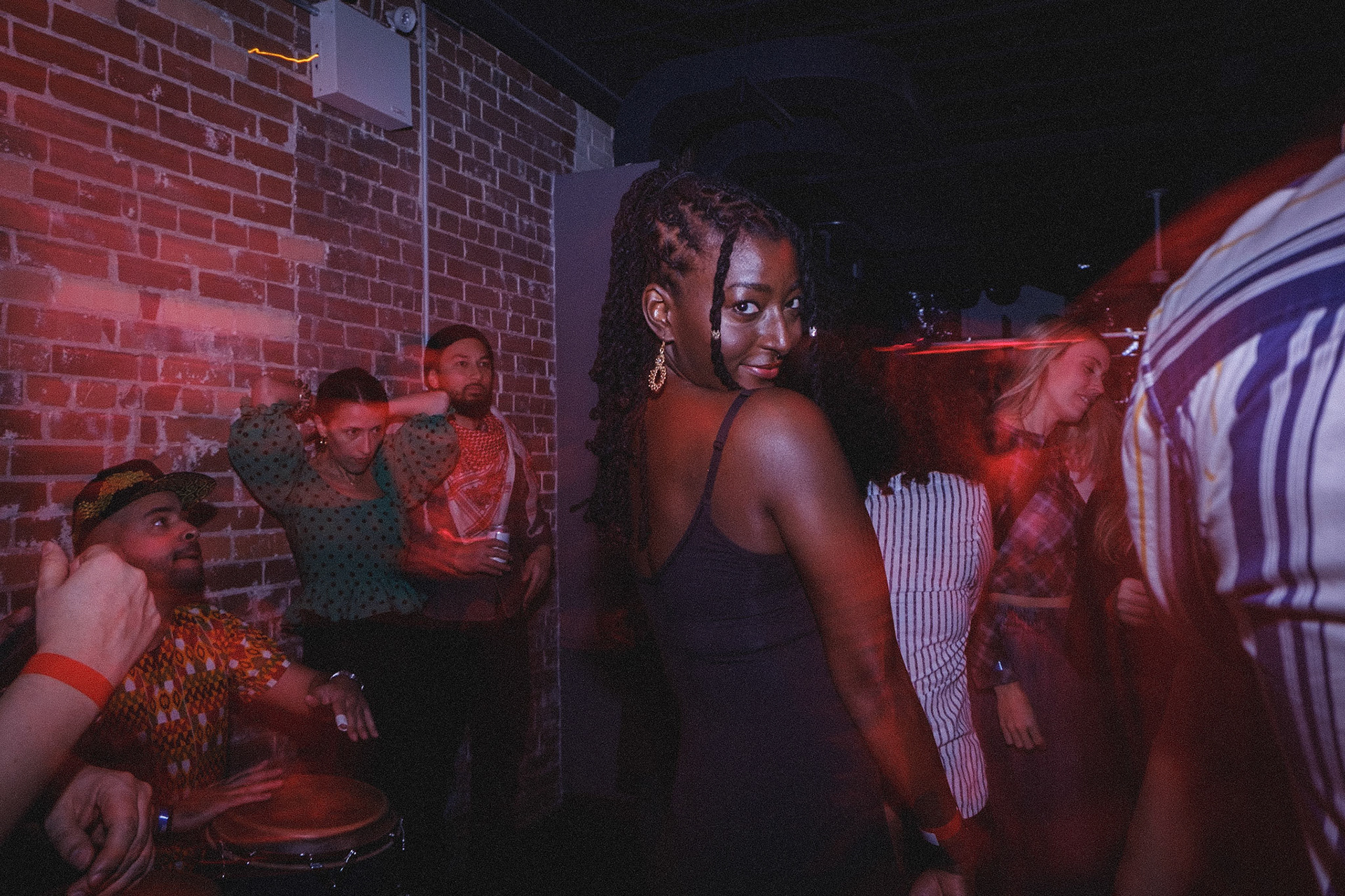 Explore Toronto’s nightlife through close-up shots and the glow of drag flash effects at Rumba Buena’s unforgettable party scene.