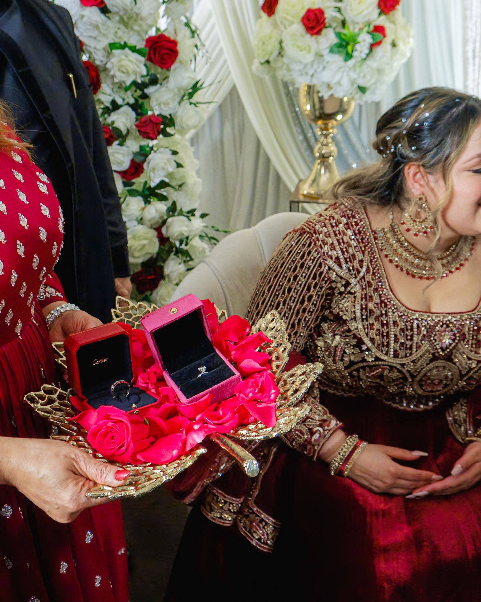 Couple seated in traditional South Asian attire during ring ceremony, Toronto engagement party photography