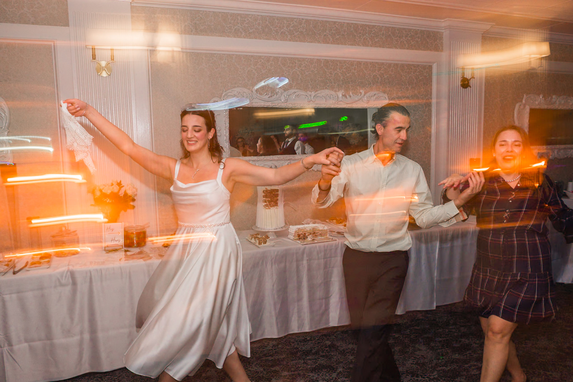 Bride and groom raising their arms together in celebration during the food serving at a Toronto engagement event