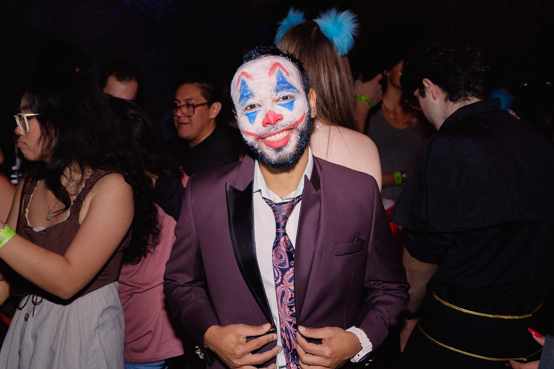 Guests in costume dancing under dramatic lighting at a Halloween party in a Toronto nightclub