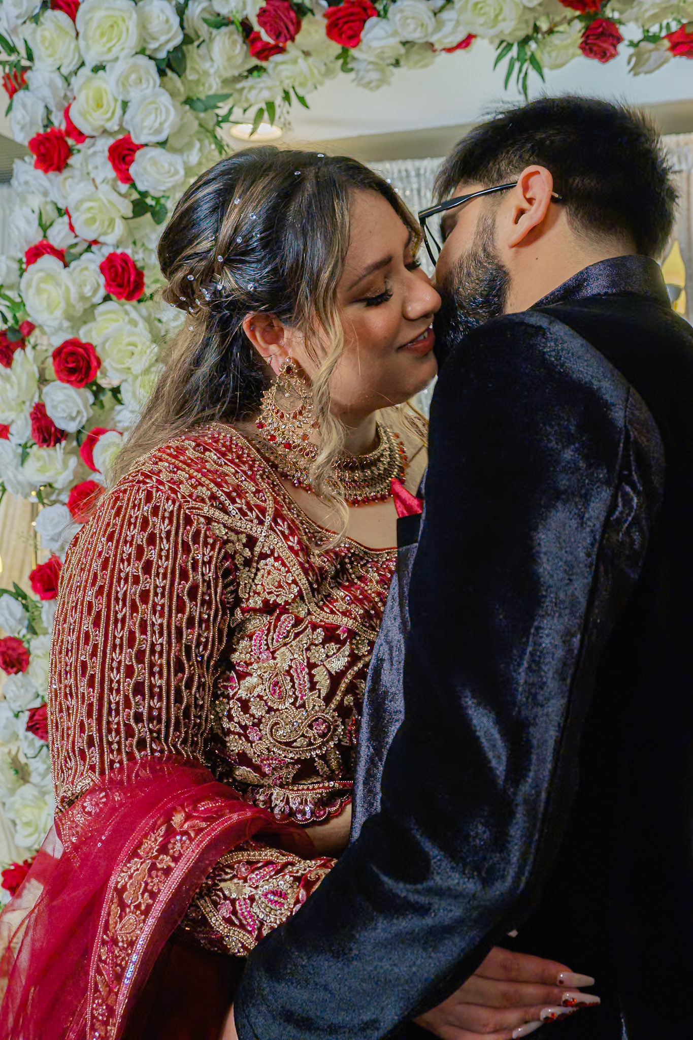 Engaged couple sharing a romantic kiss in traditional South Asian attire during engagement ceremony in Toronto, captured by Toronto photographer Cristian Arango