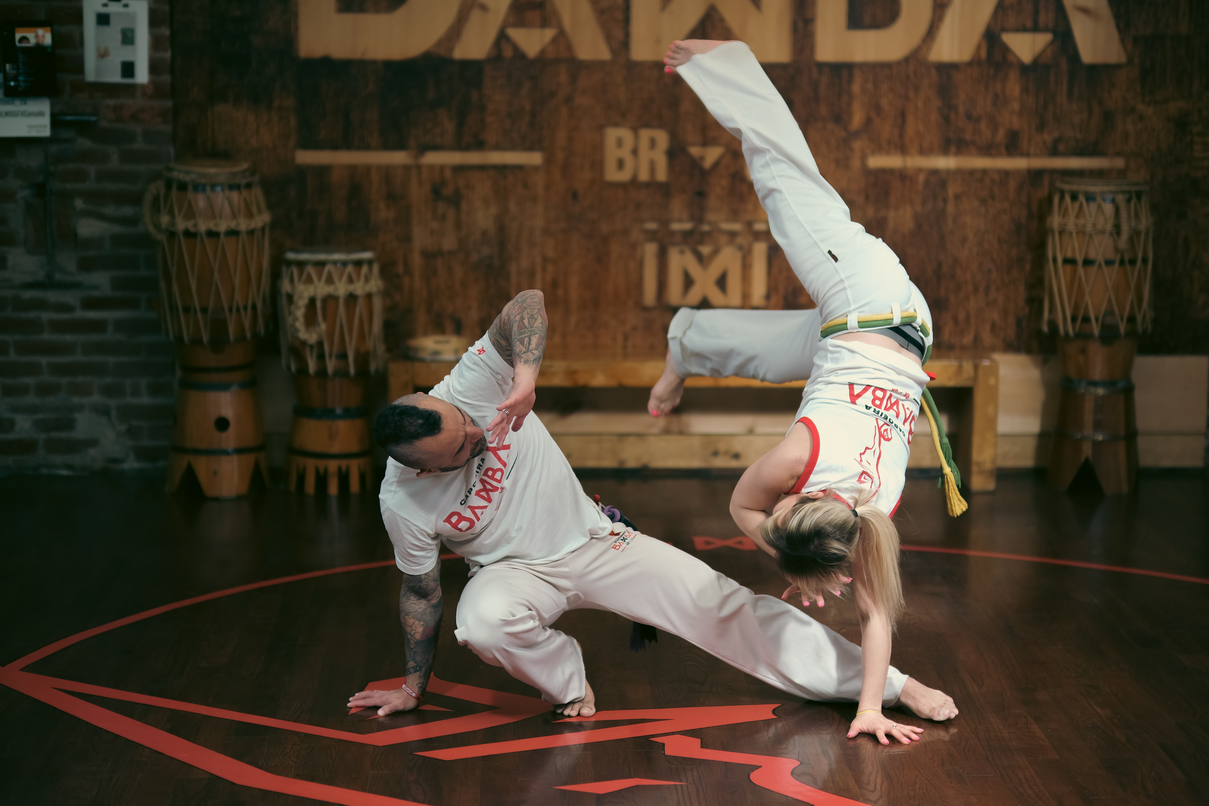 Mid-action Capoeira pose showing strength, agility, and fluid movement coordination.