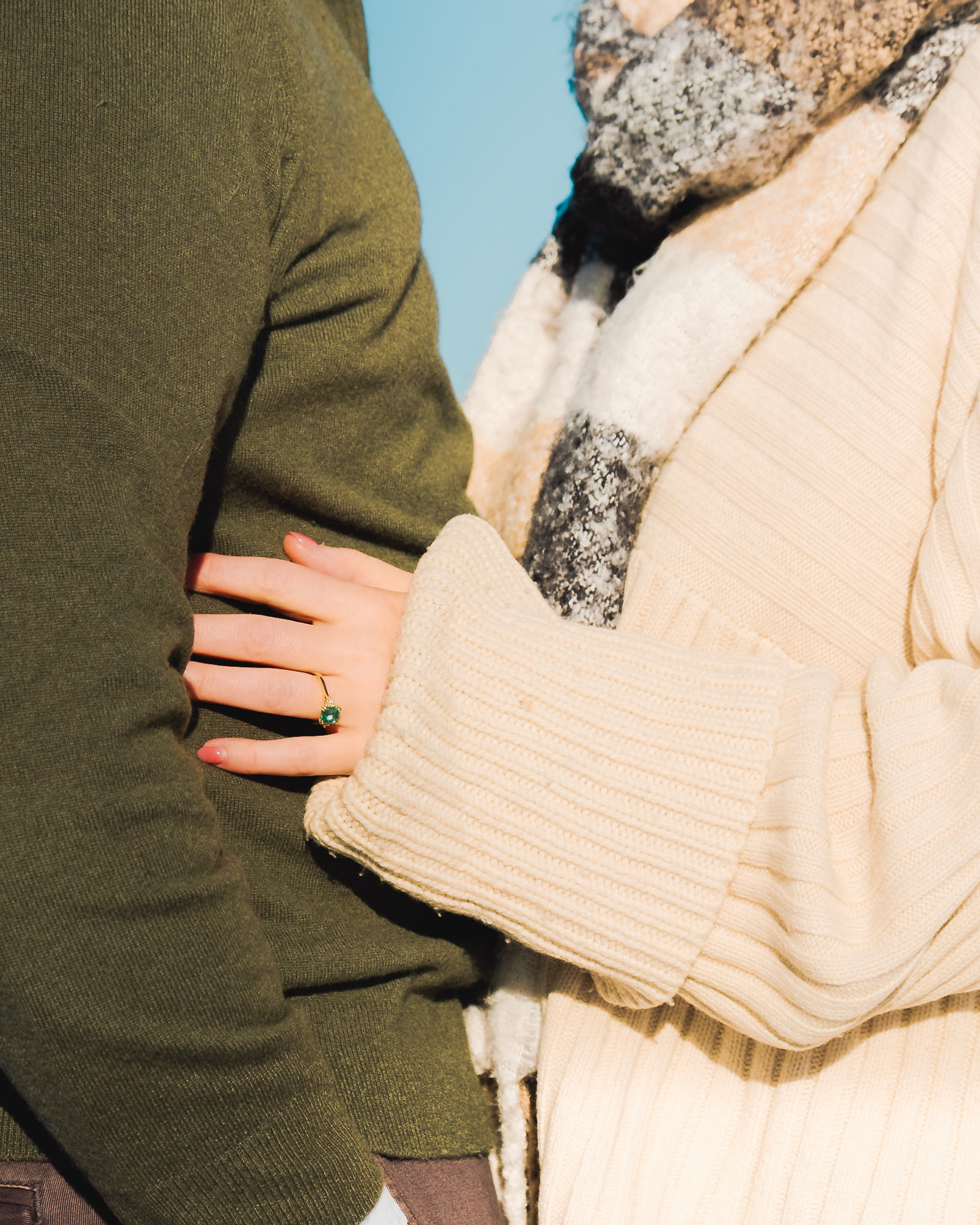 Close-up of engagement ring on fiancée’s hand during winter proposal by the lake in Toronto